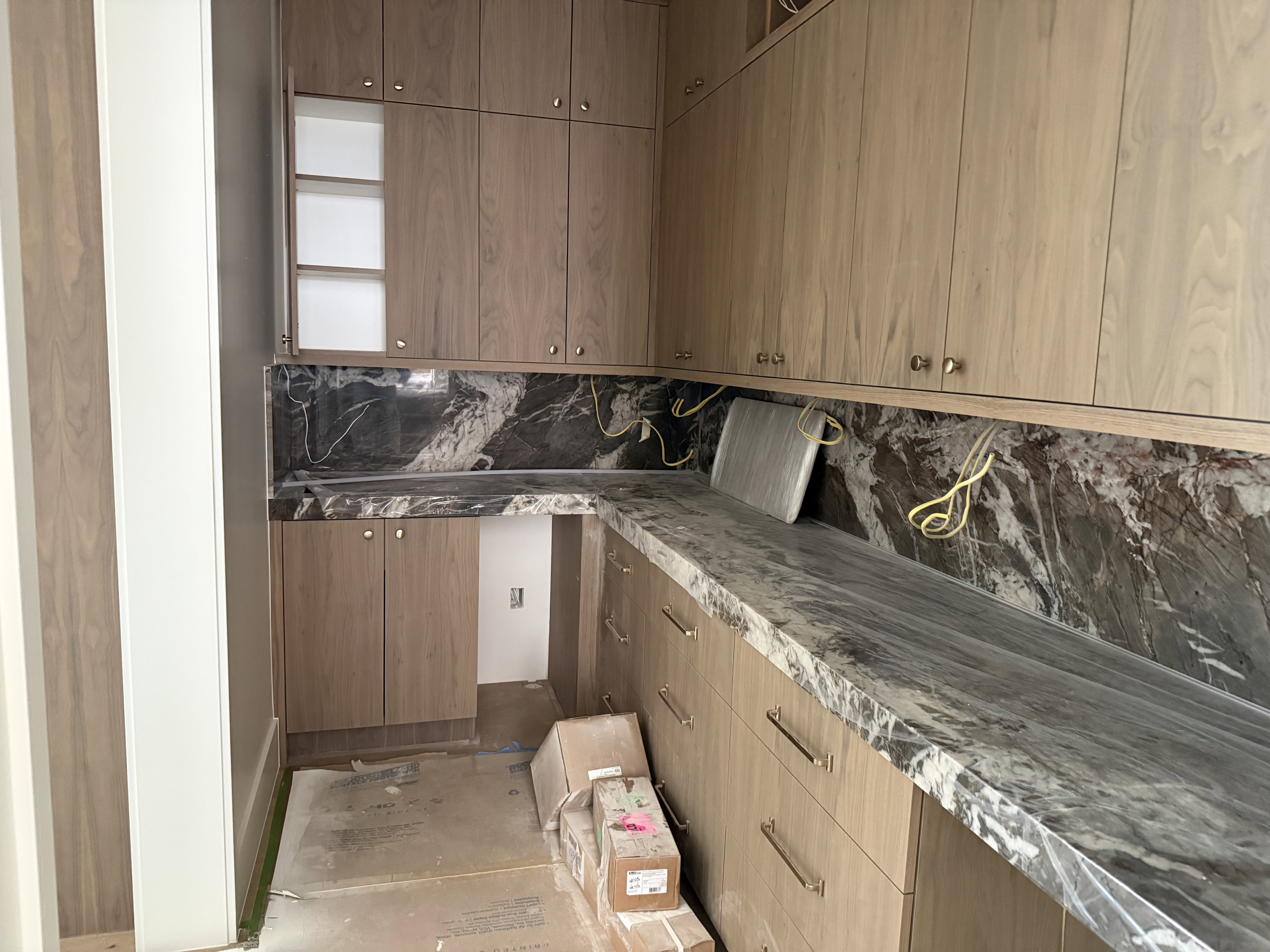 Custom cabinetry with wood-finish doors and brass hardware