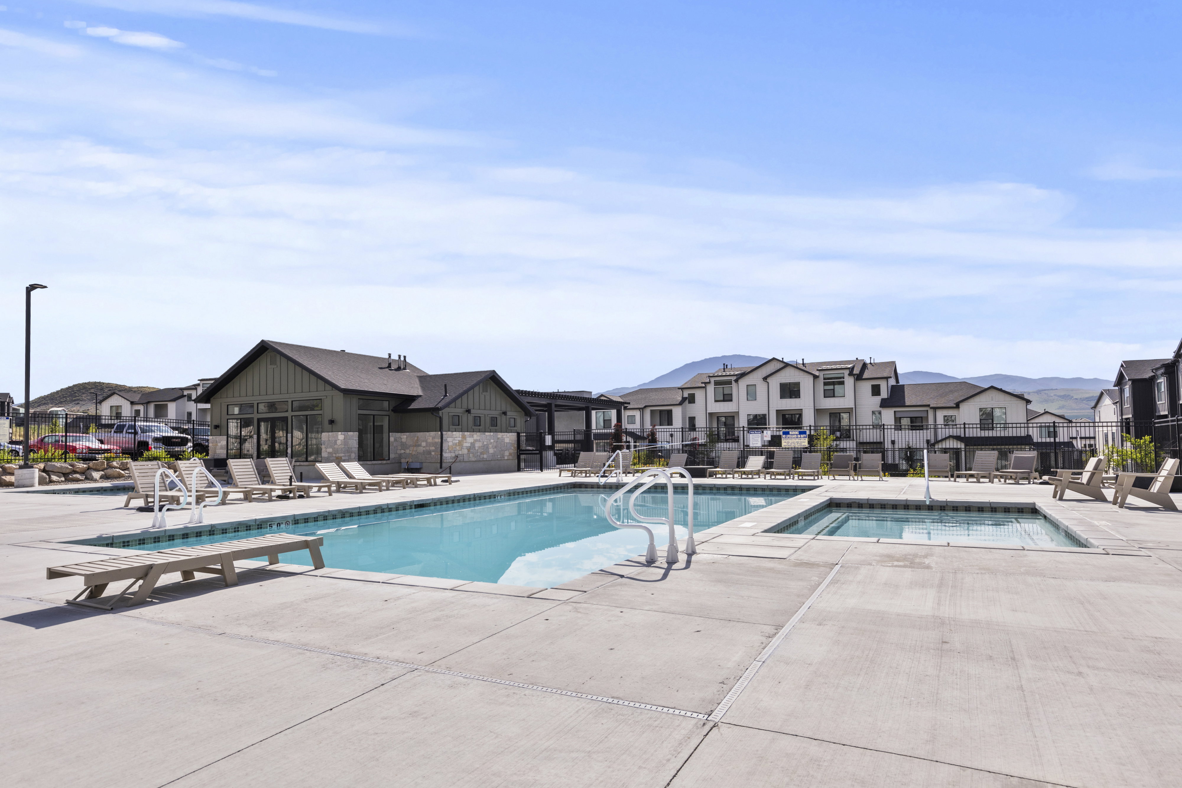 Community pool and spa with surrounding concrete decking
