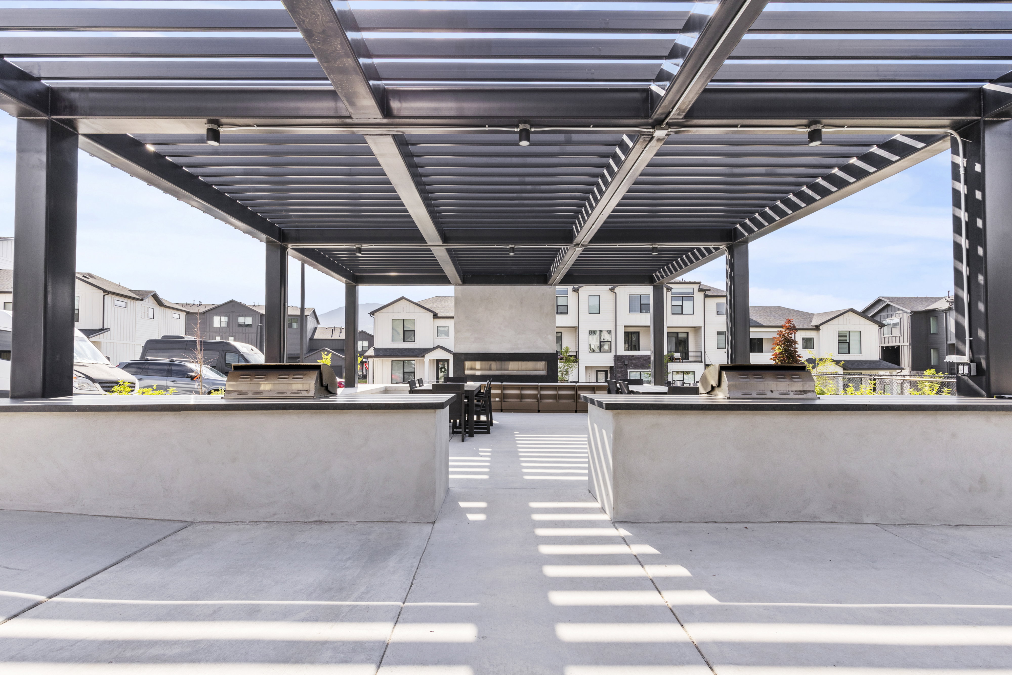 Outdoor entertaining space featuring a louvered pergola with integrated lighting