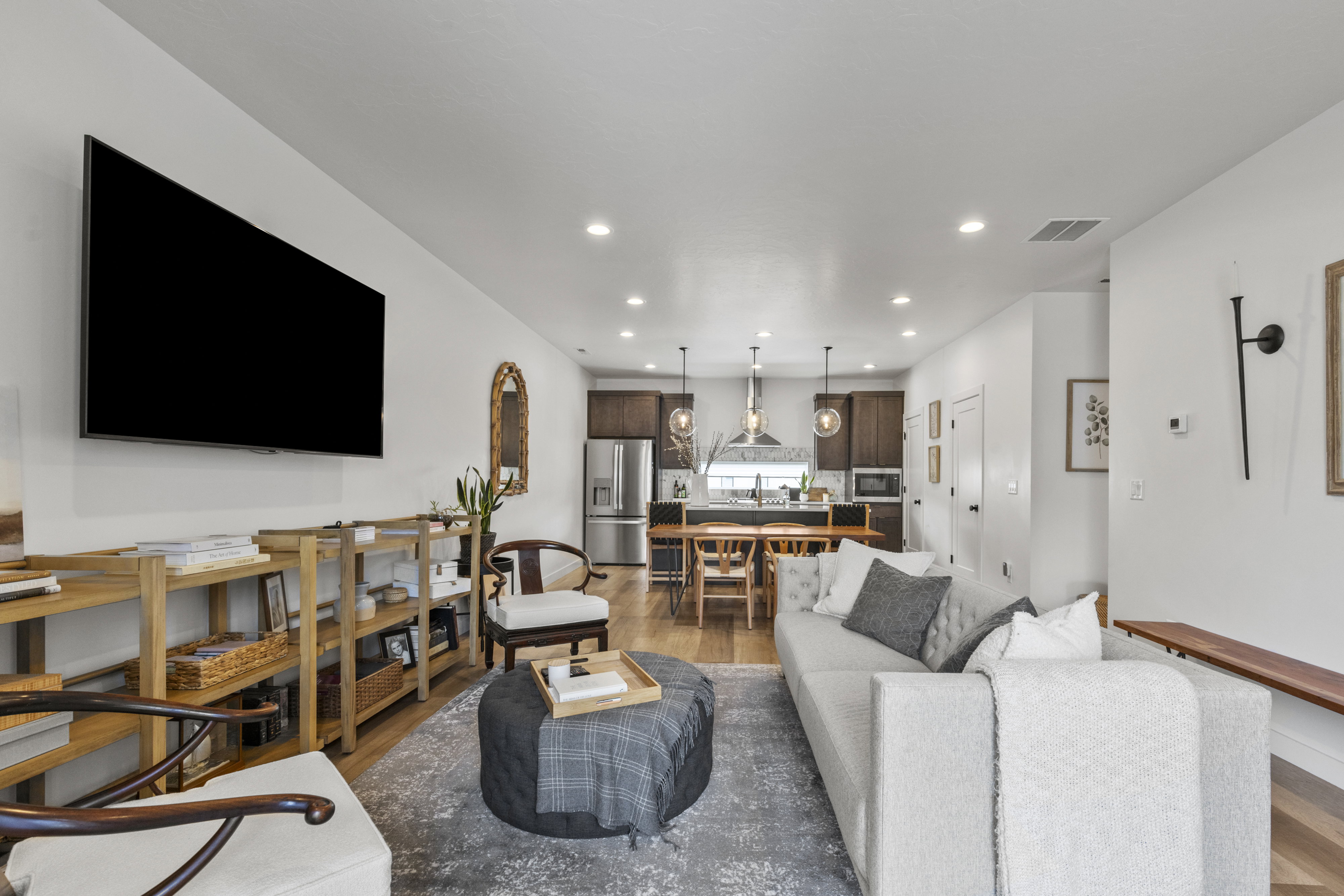 Open-concept living area featuring hardwood flooring and recessed lighting