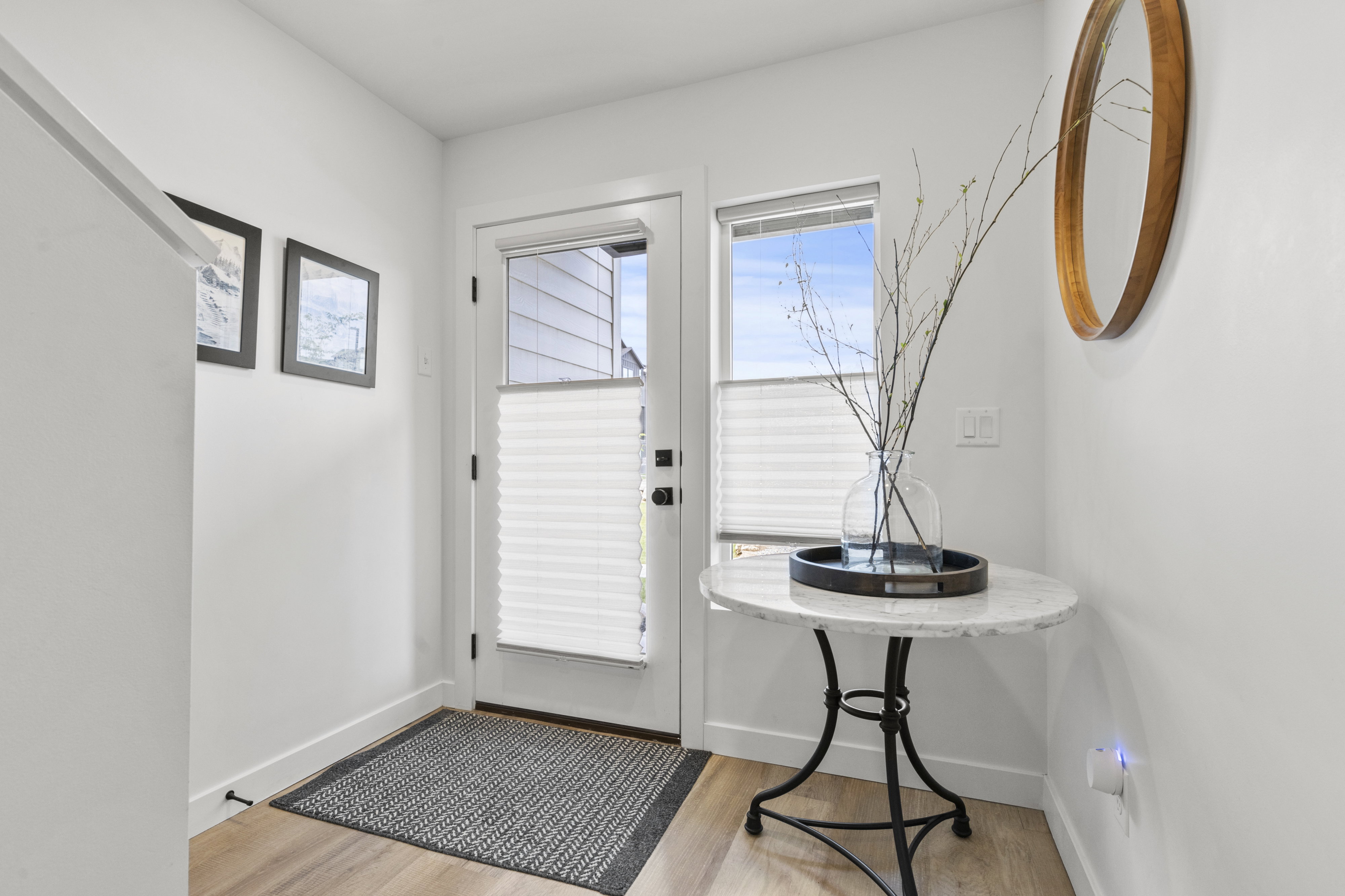 Entryway featuring wood-finish flooring and crisp white walls