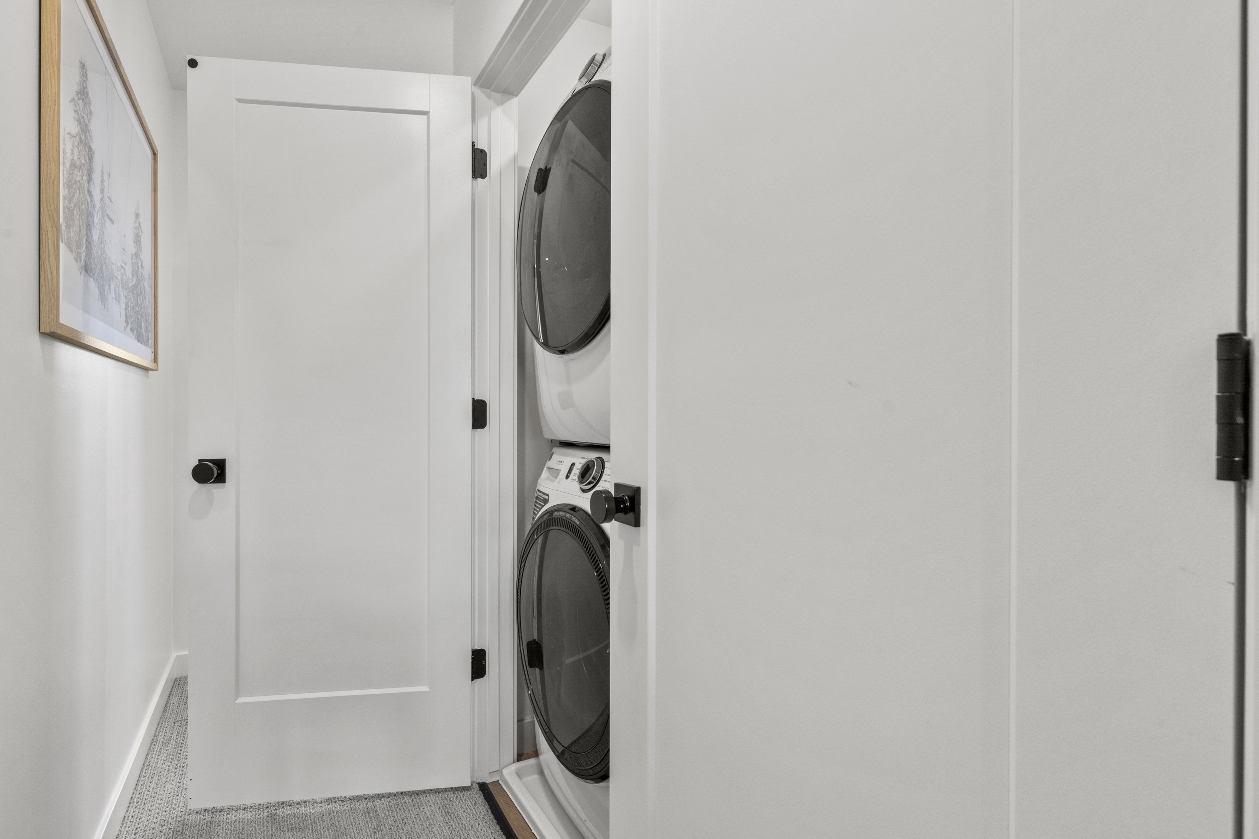 Dedicated laundry closet with a stacked washer and dryer