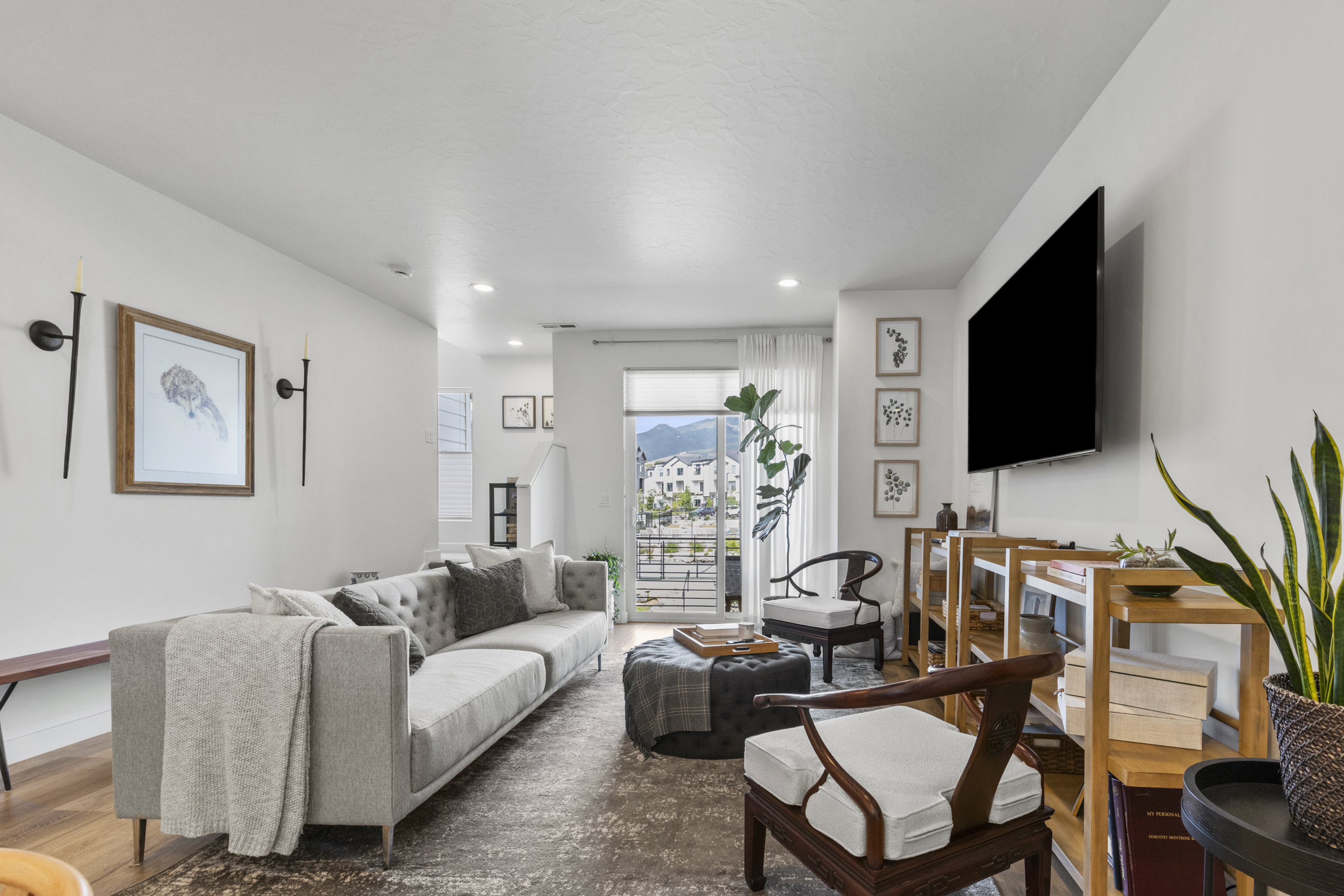 Living area featuring a sliding glass door, recessed lighting, and wood-finish flooring