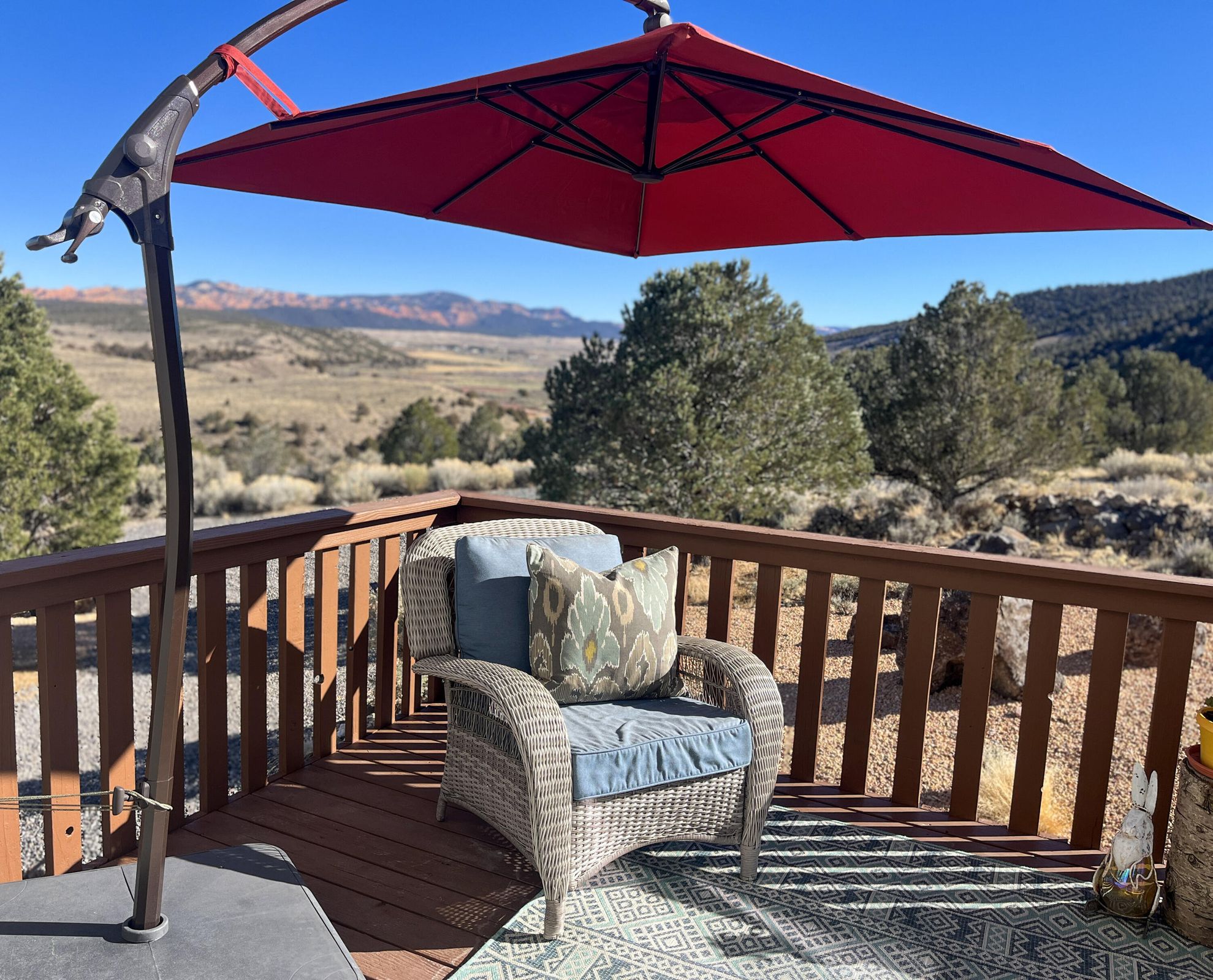 Expansive outdoor deck featuring a rich brown wood-finish railing and decking