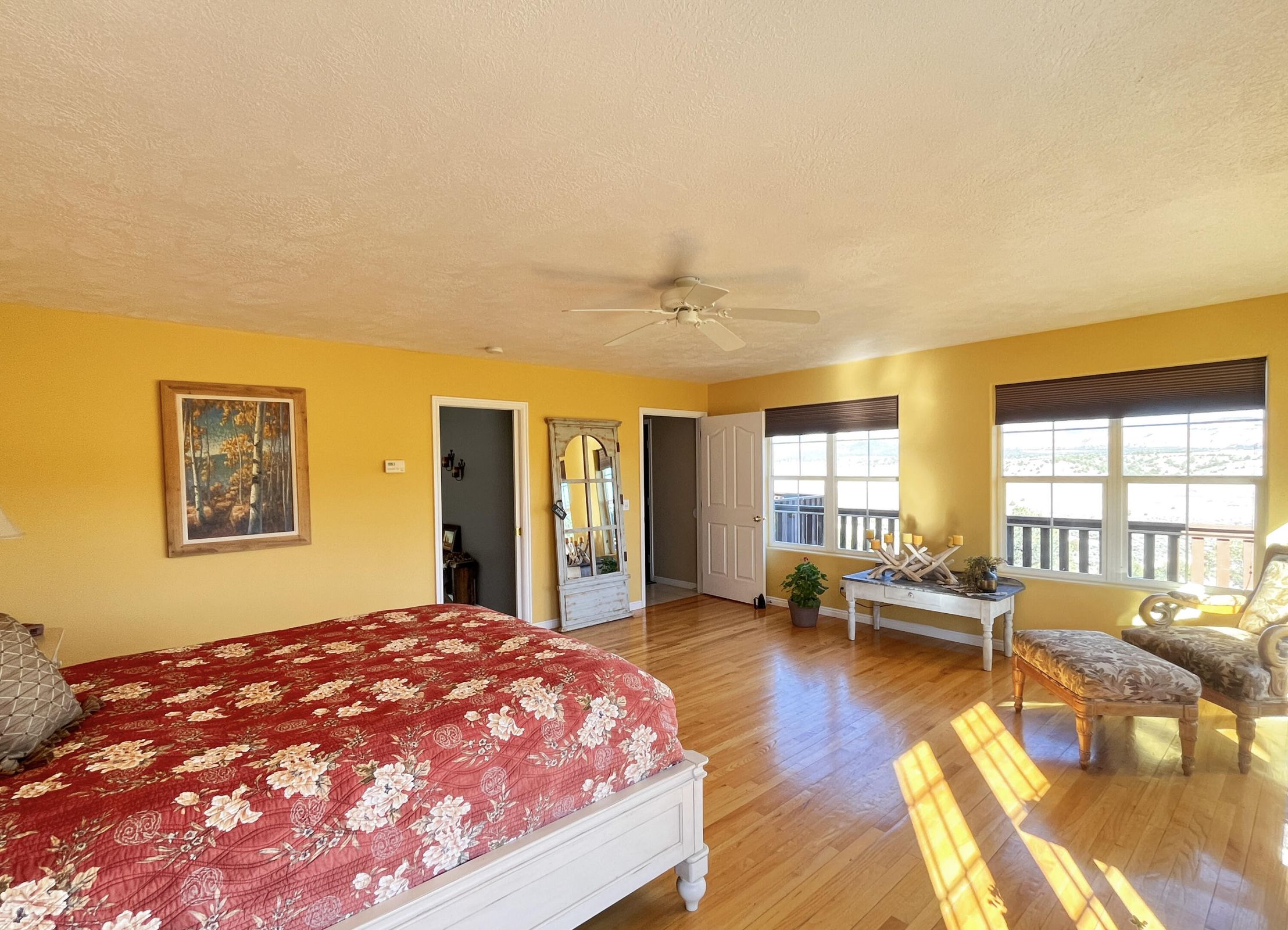 Spacious room featuring wood-finish flooring and a ceiling fan