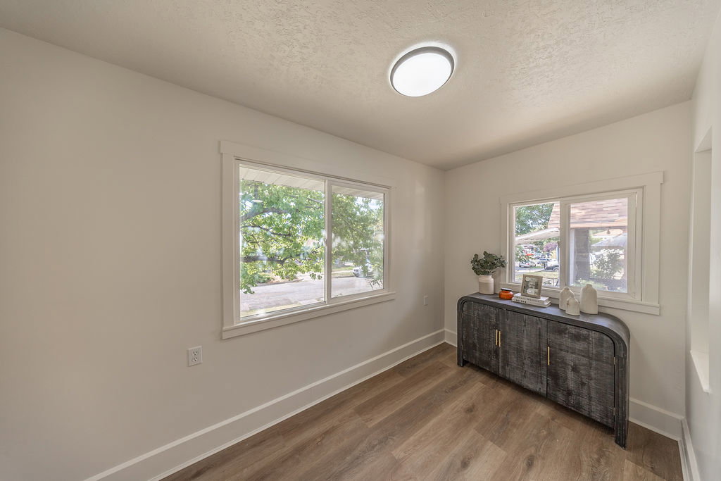 Neutral-toned walls complement the wood-finish flooring