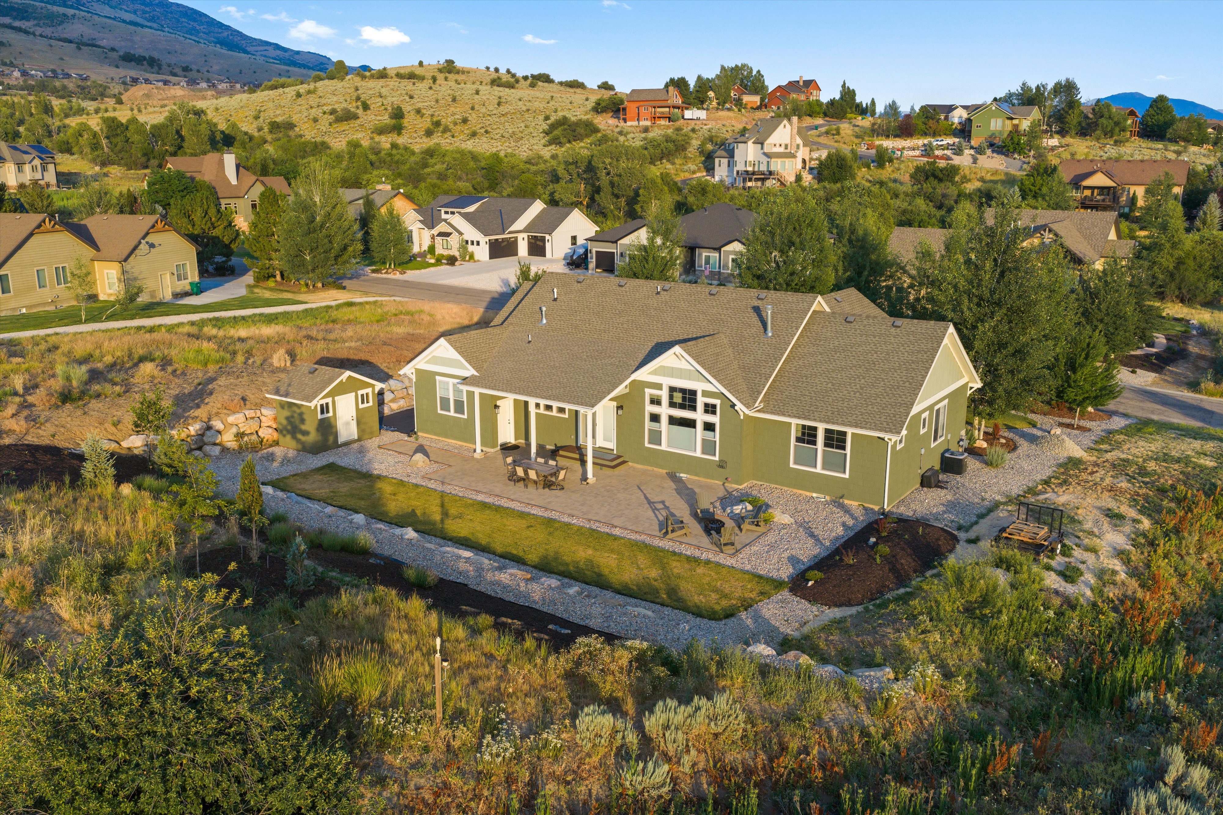 Single-story residence featuring green siding and a grey roof
