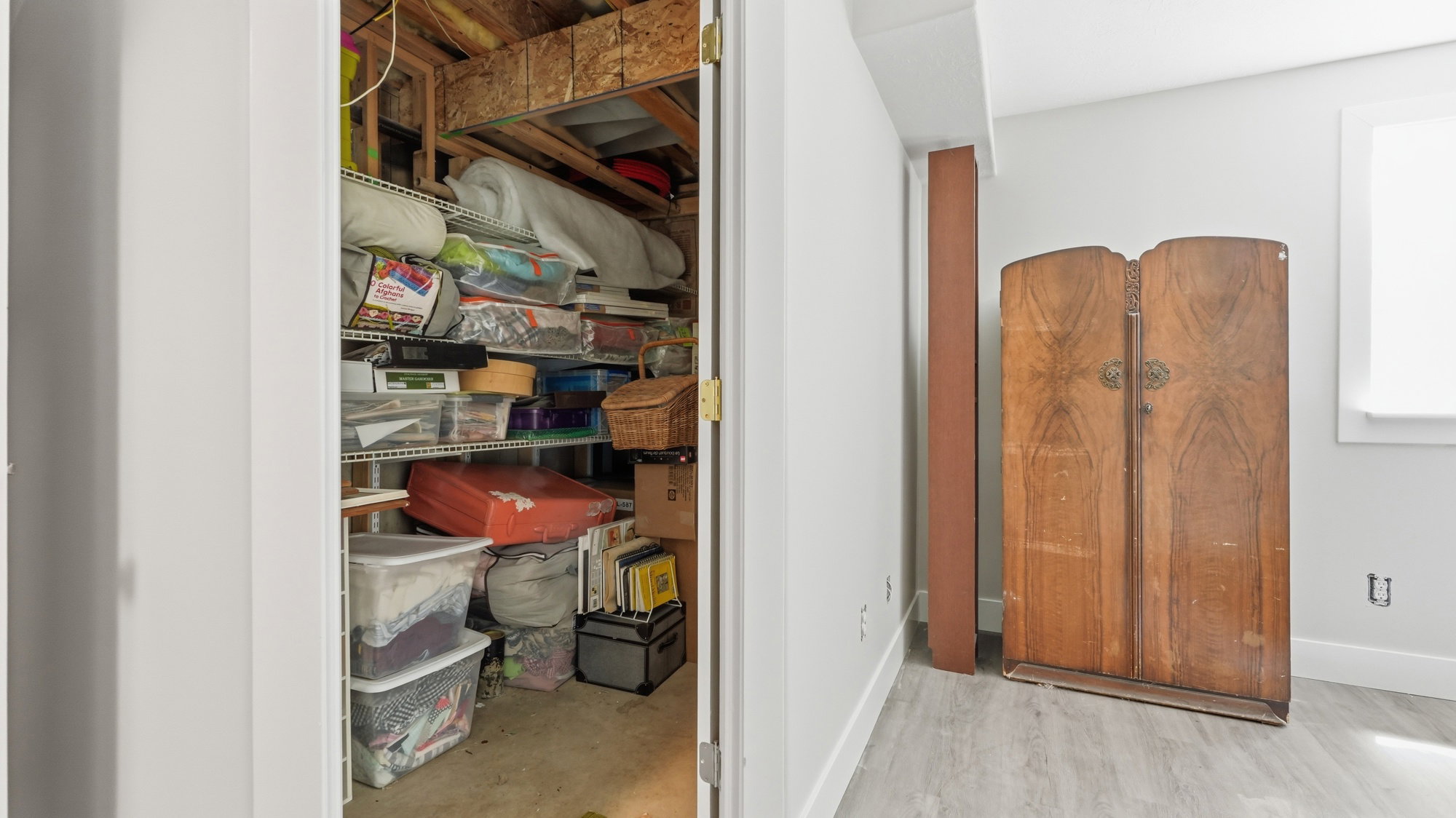 Unfinished utility space featuring exposed ceiling joists and concrete flooring