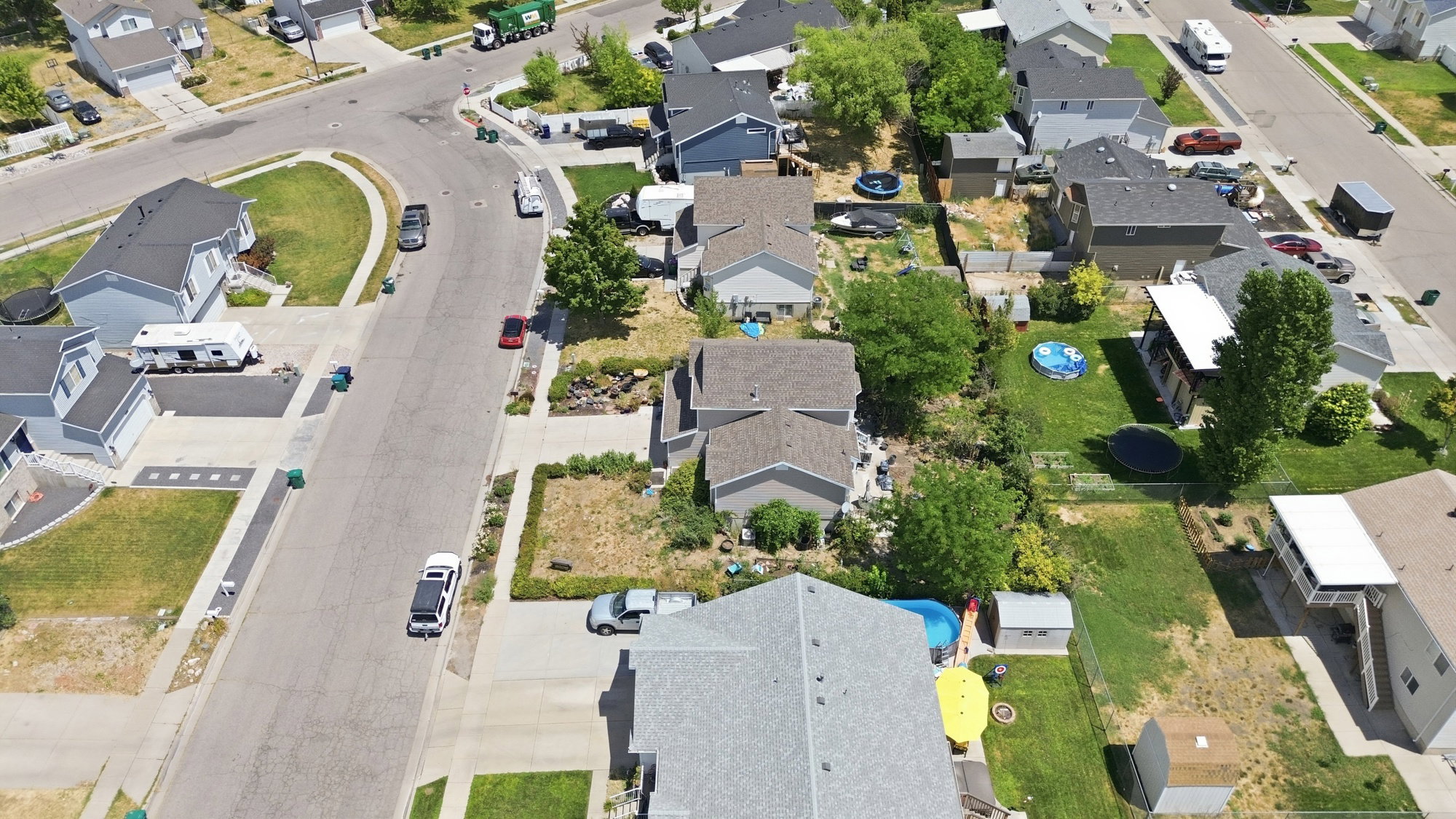 Aerial perspective showcasing a residential neighborhood with gray-roofed homes