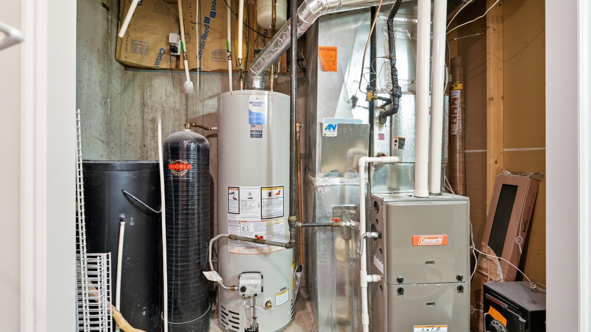 Heating and cooling systems with water heater and water treatment unit