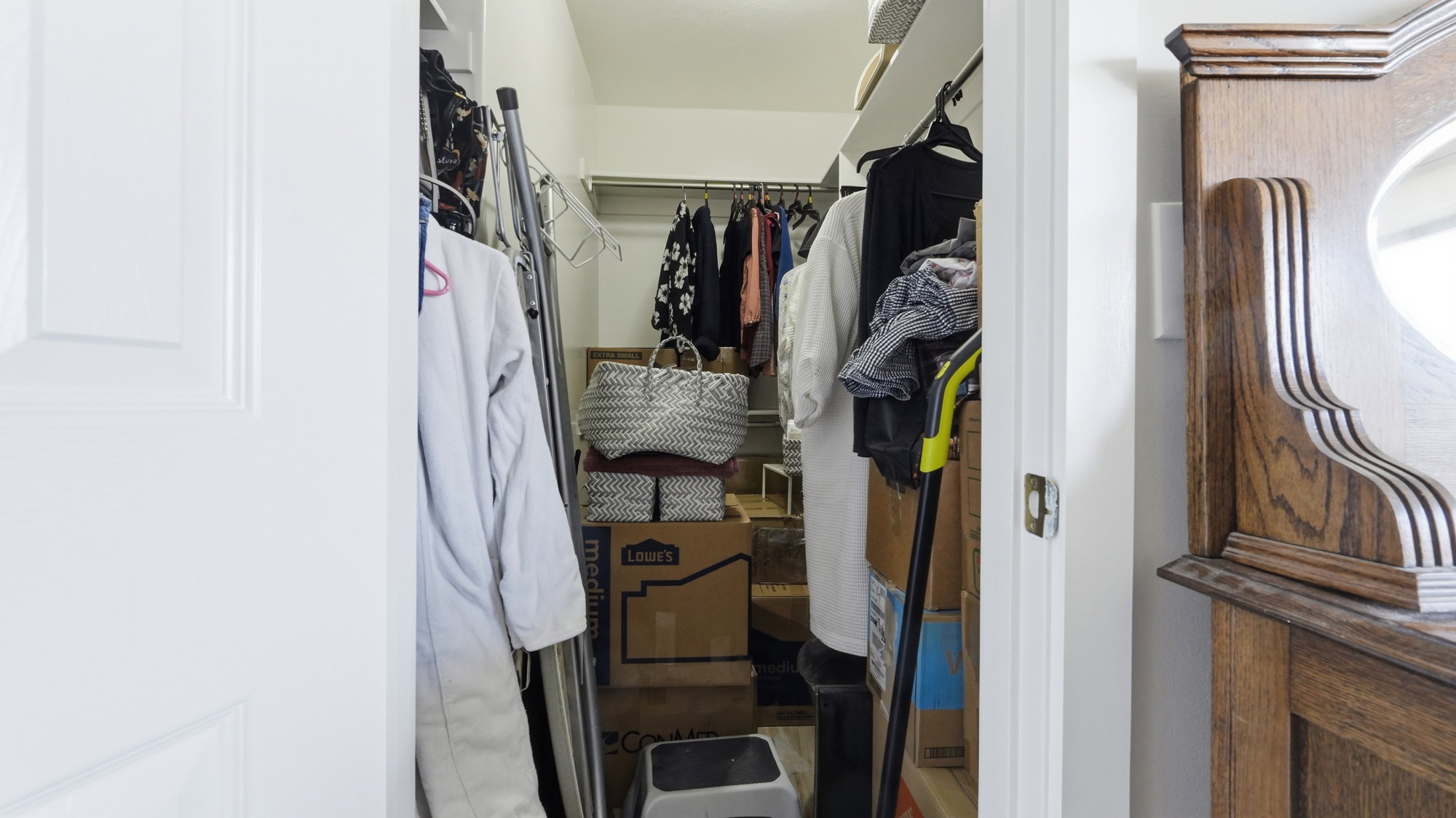 Walk-in closet with built-in shelving in primary bedroom