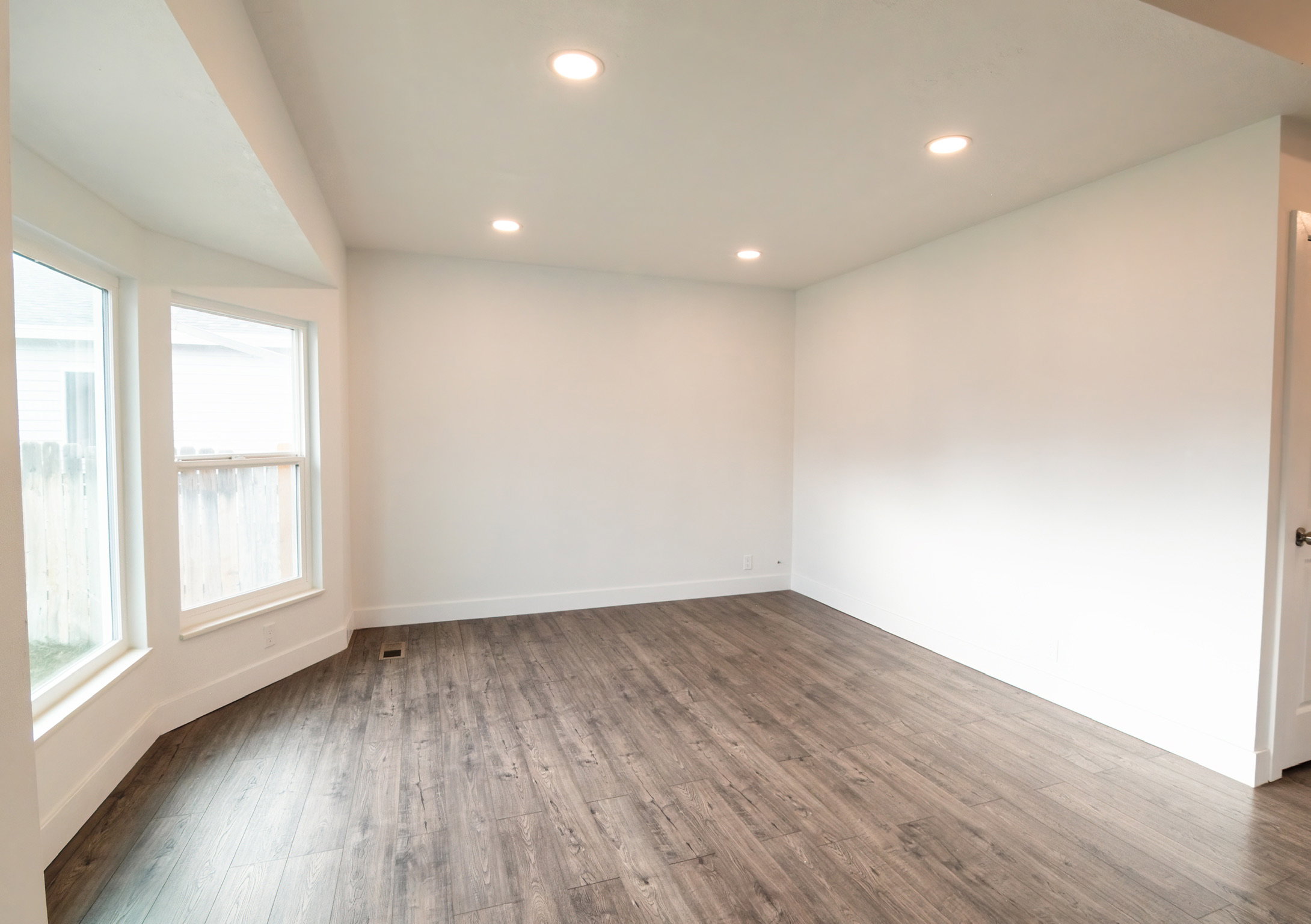 Bright interior space featuring wood-finish flooring, white walls, and recessed lighting