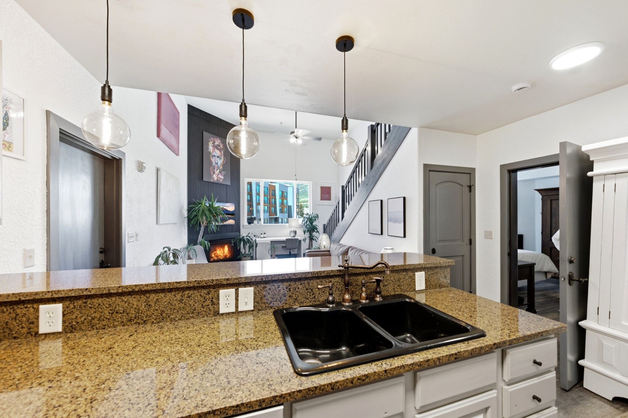 Granite-finish countertops featuring a dual basin sink and bronze-finish faucet