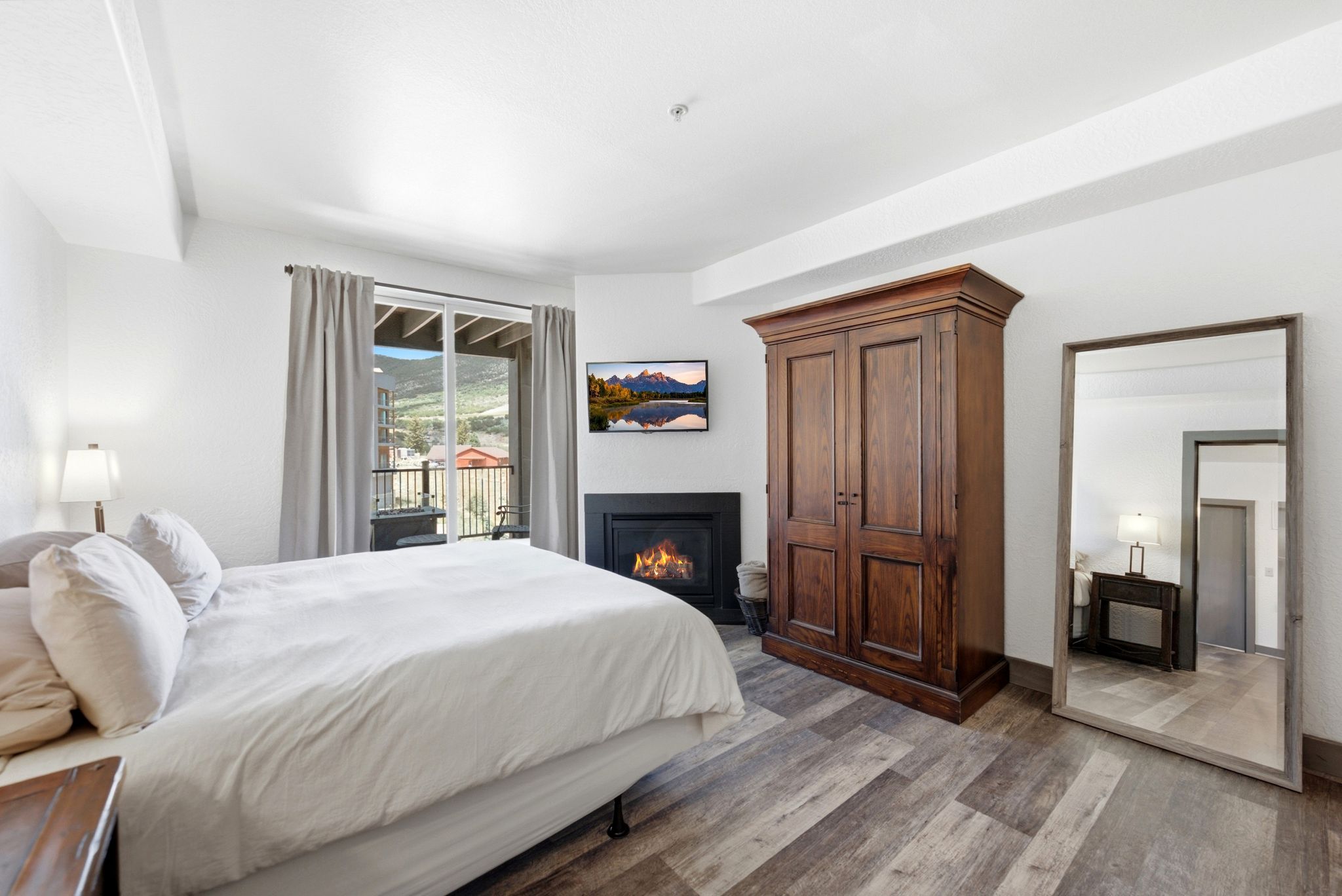 Interior space featuring wood-finish flooring, a built-in fireplace, and a sliding glass door providing outdoor access