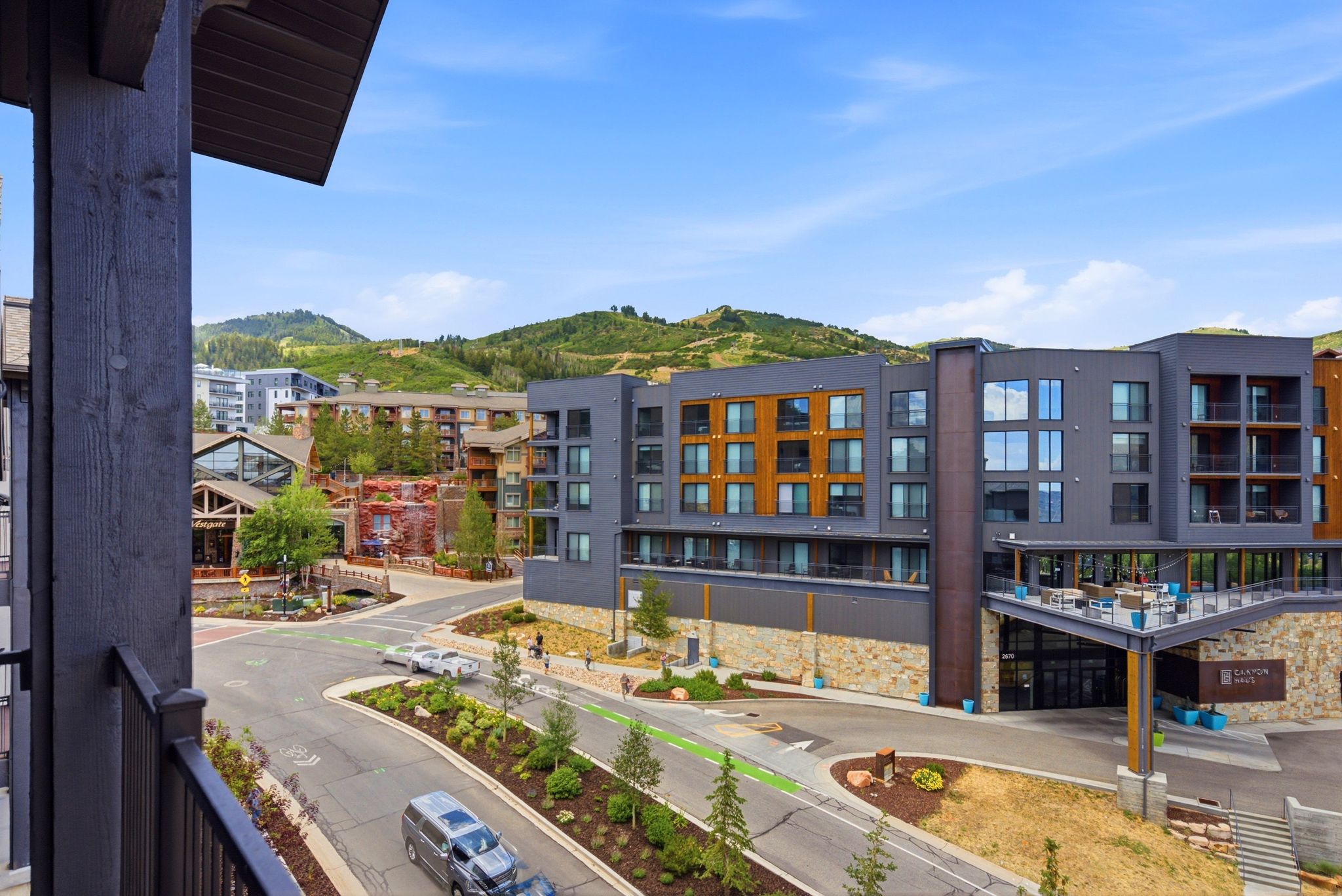 Community setting featuring modern architecture with stone and wood-finish accents