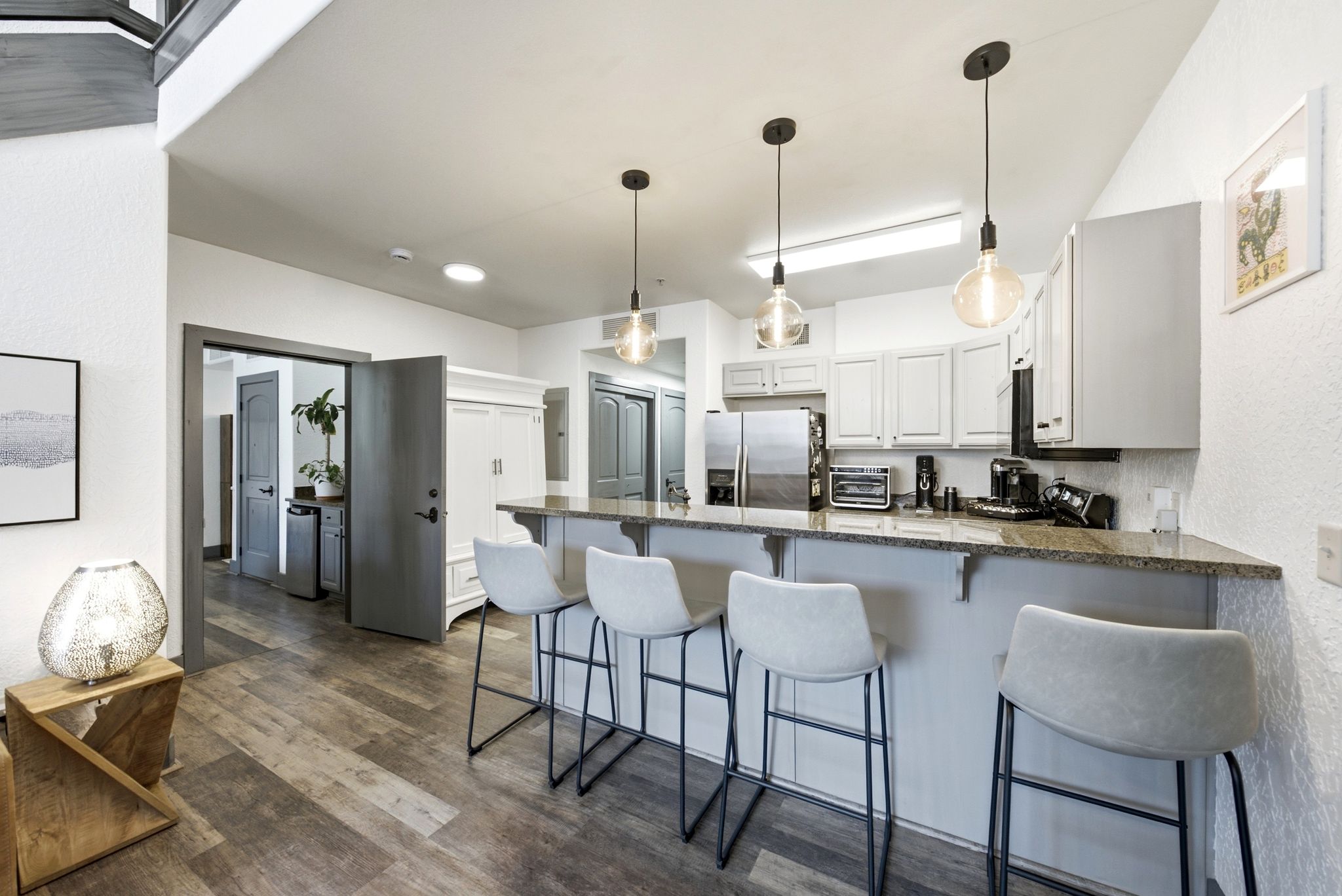 Kitchen island with a granite countertop and pendant lighting