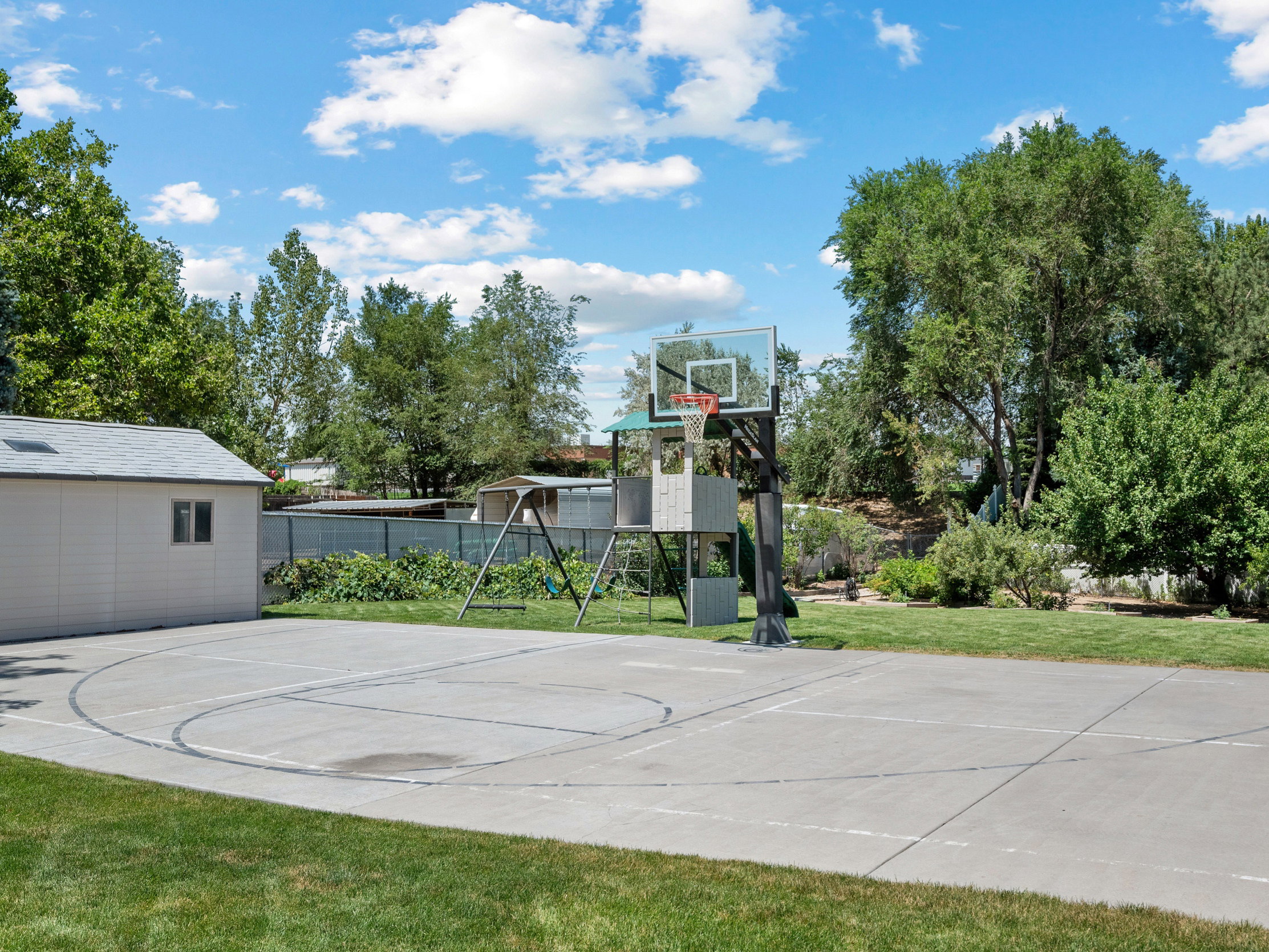Anchored basketball hoop with painted basketball and pickleball lines