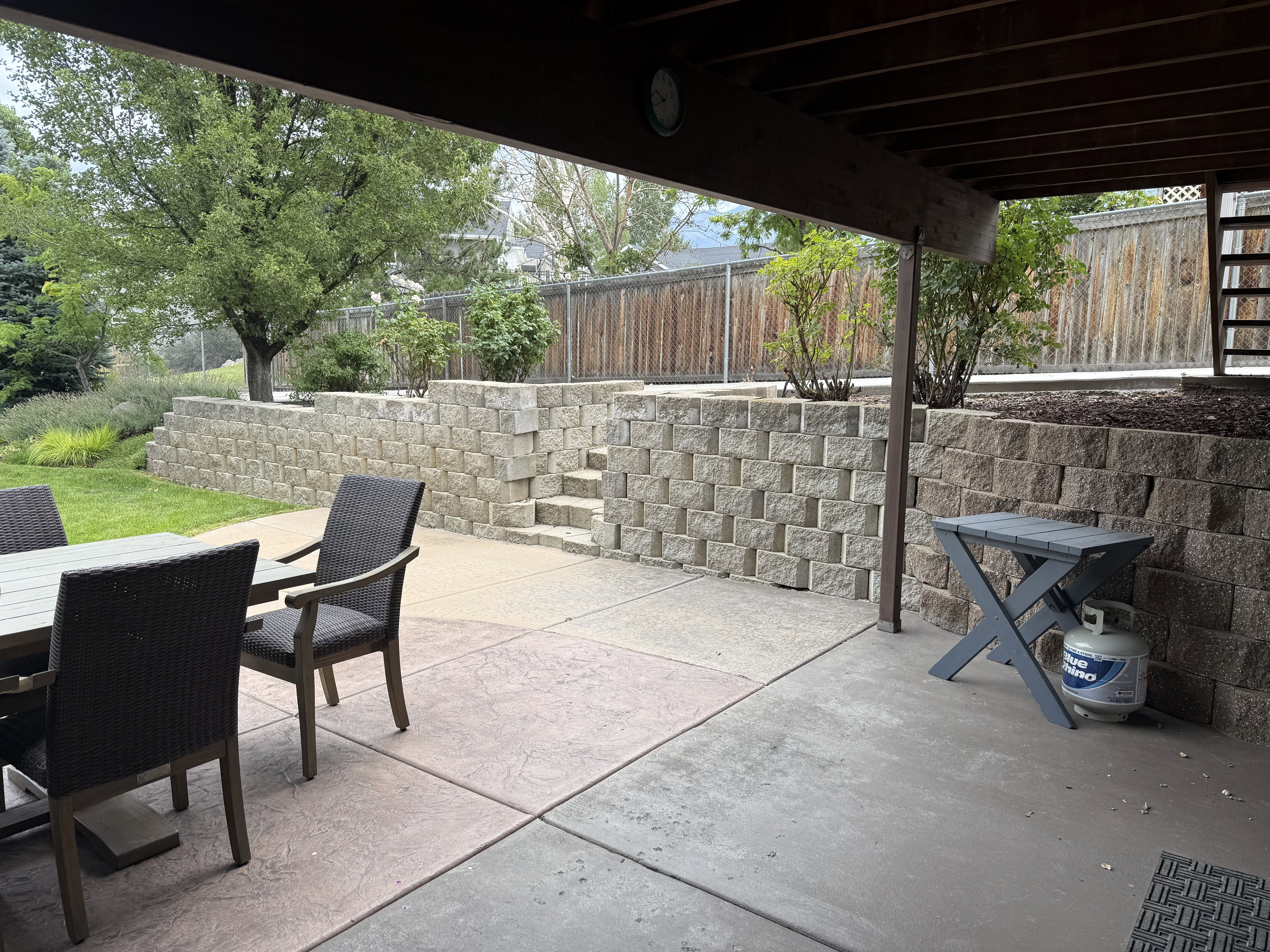 Expansive patio featuring a concrete surface and integrated retaining walls