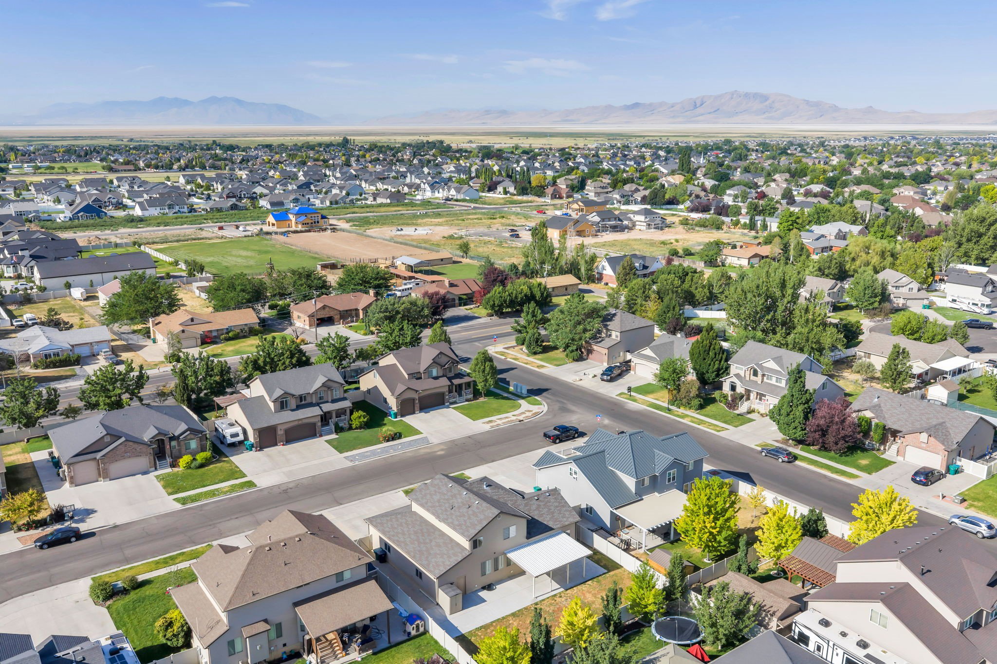 Expansive residential neighborhood featuring diverse architectural styles, mature landscaping, and paved streets