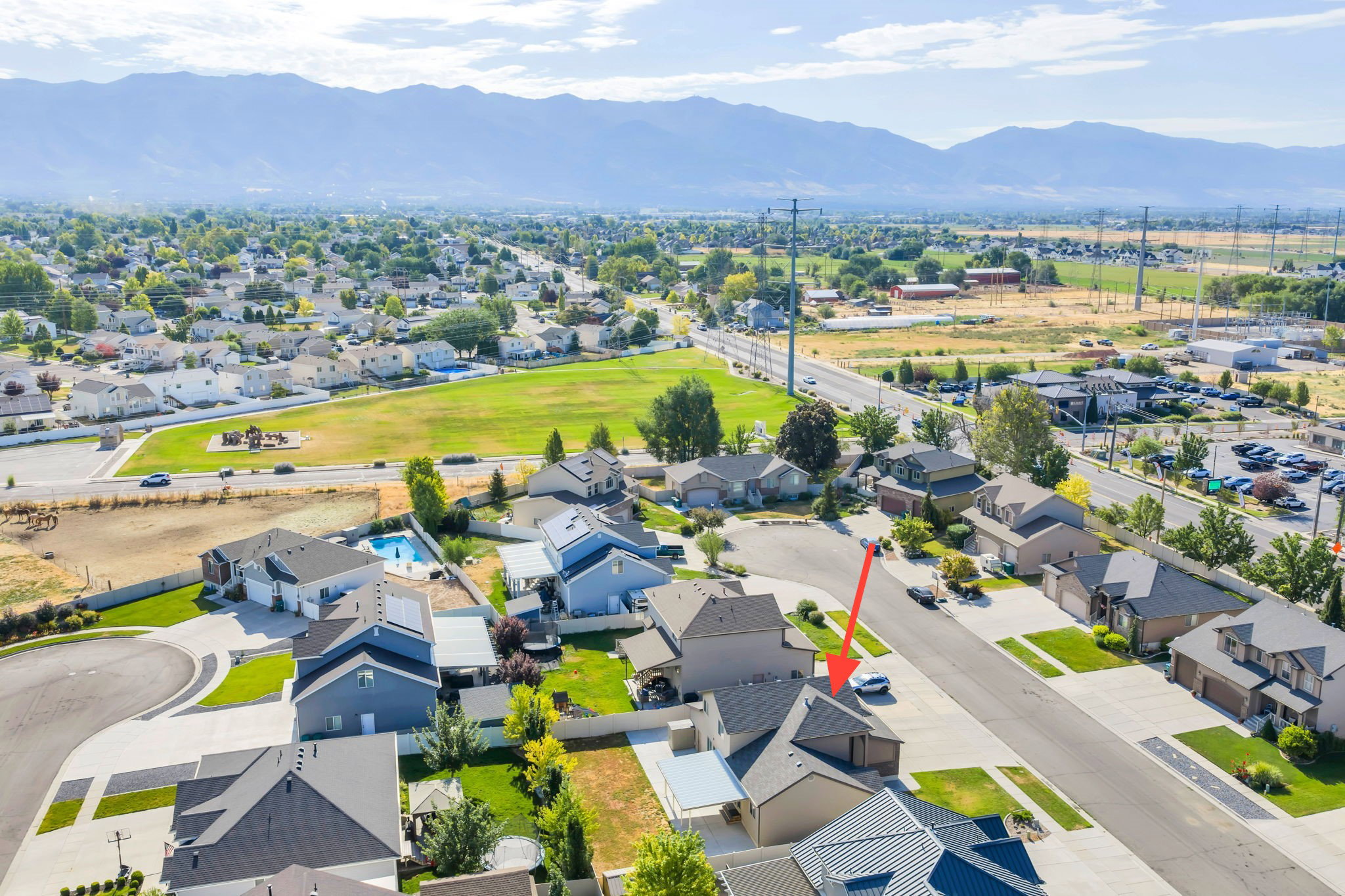 Aerial perspective showcasing the residential neighborhood with mountain backdrop