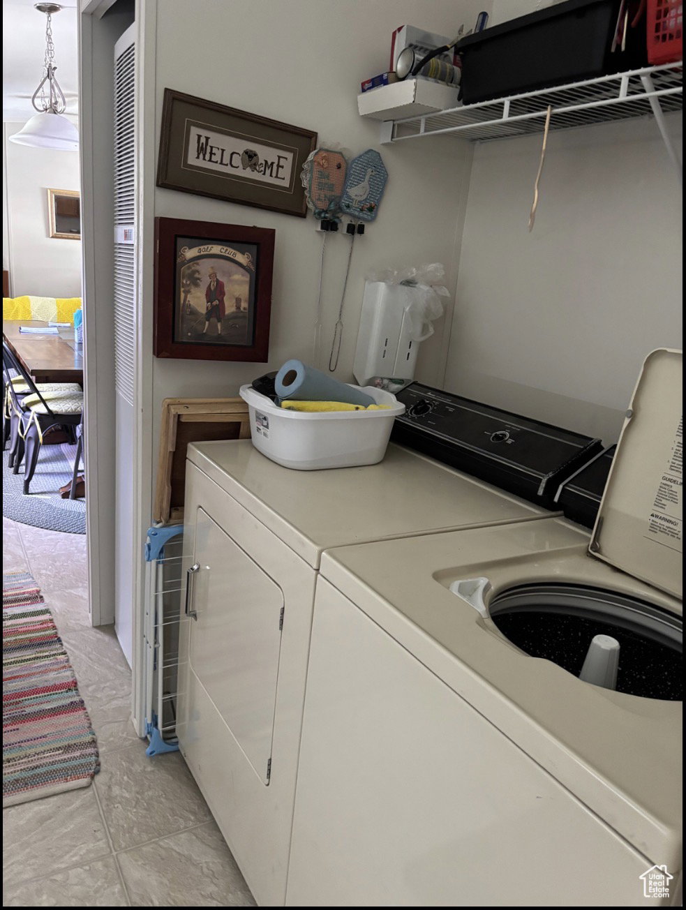 Dedicated laundry area featuring a top-load washing machine and front-load dryer