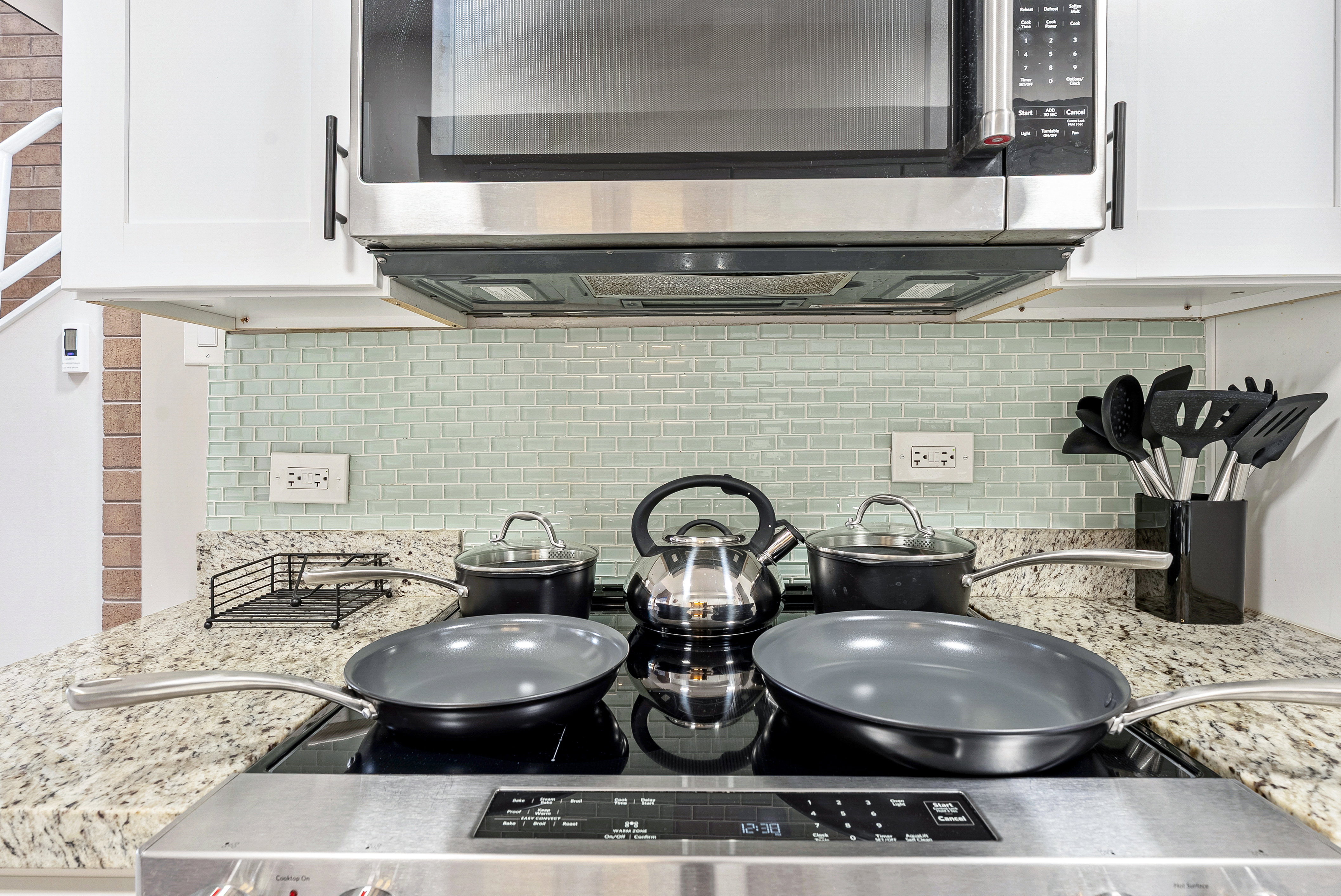 Built-in stainless steel microwave over a flat-top electric range
