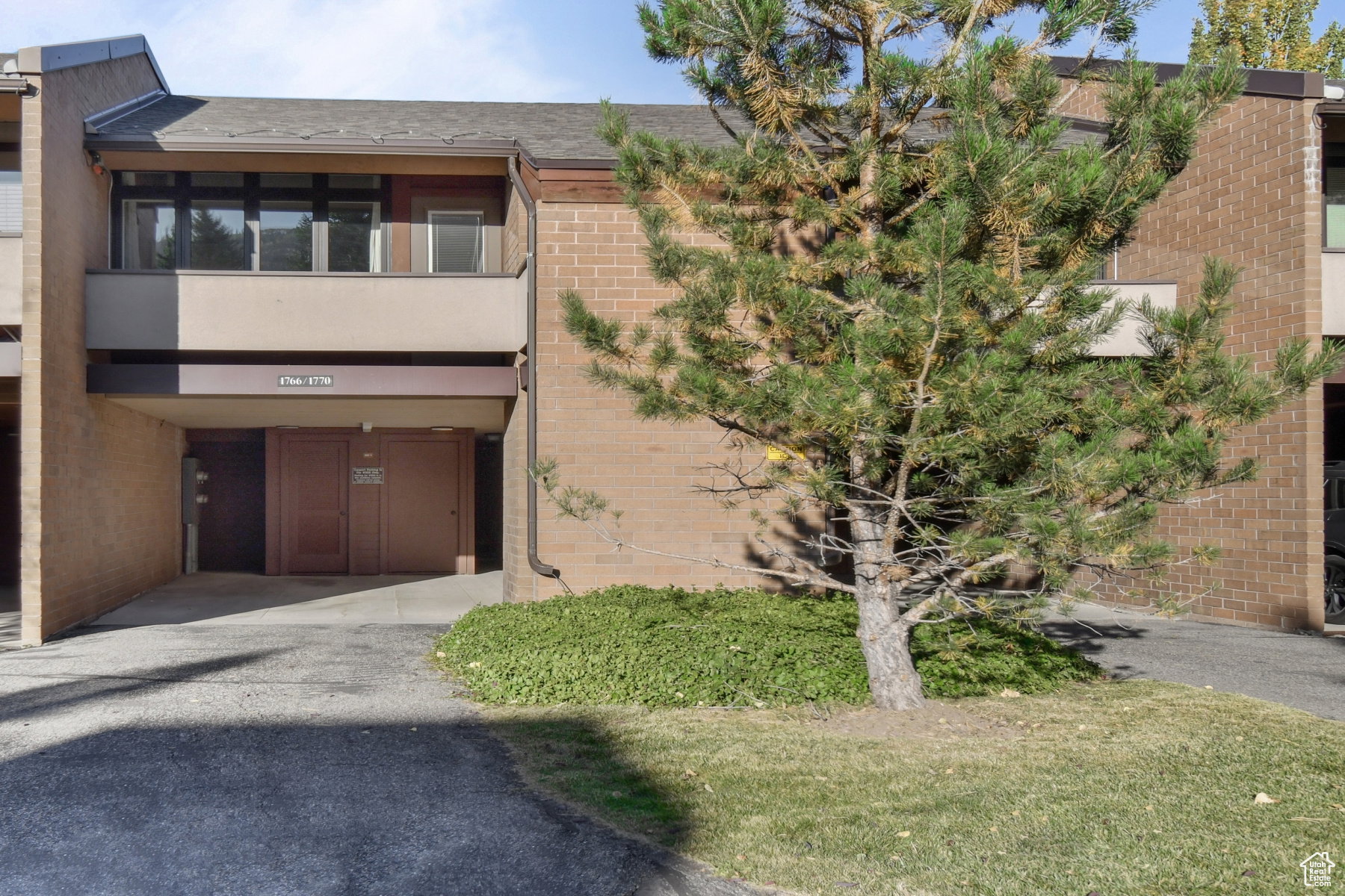 Brick and panel exterior with a prominent balcony