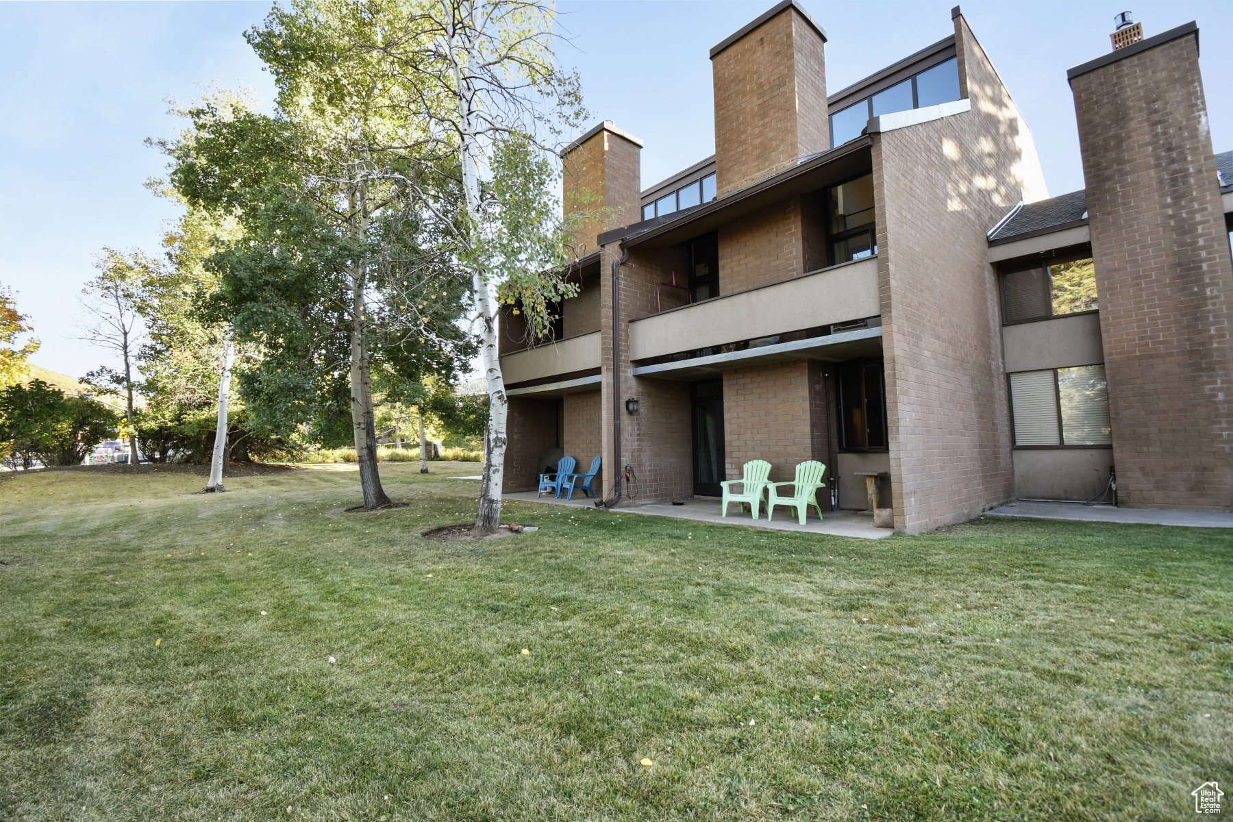 Brick facade building featuring multiple levels with balconies and patios