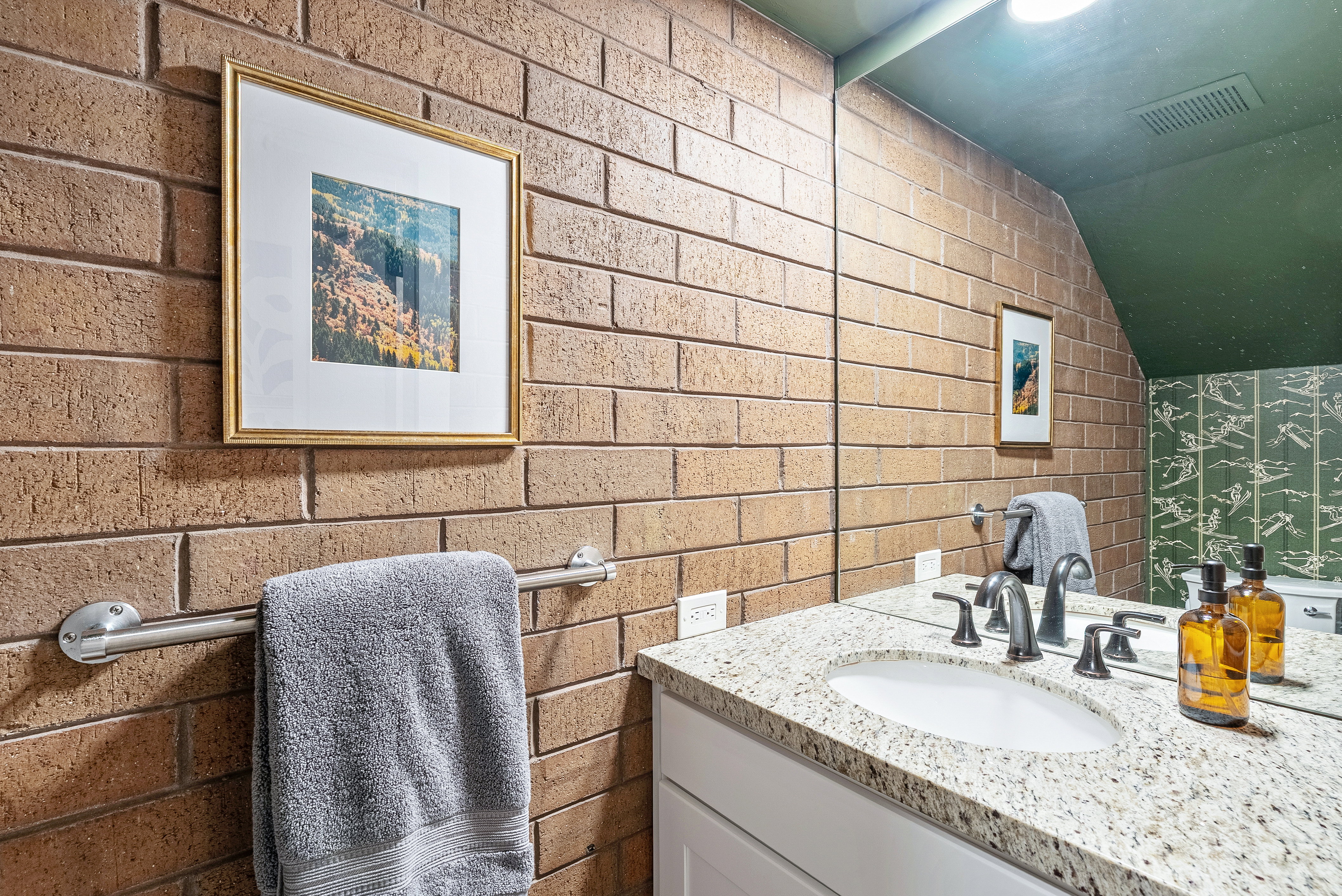 Vanity featuring a built-in sink, granite countertop, and dark-finished faucet