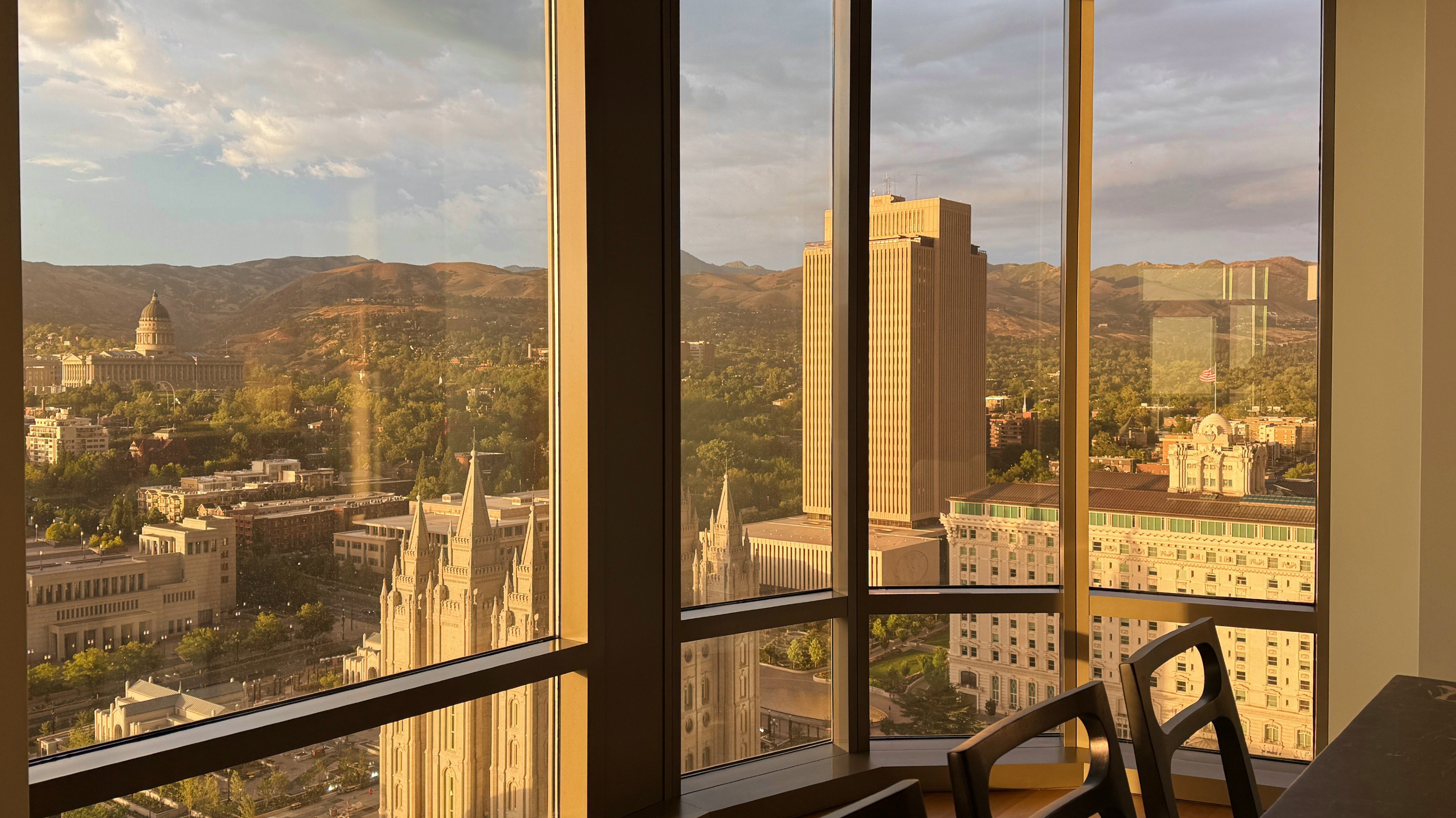 Panoramic windows showcasing cityscape and mountain scenery
