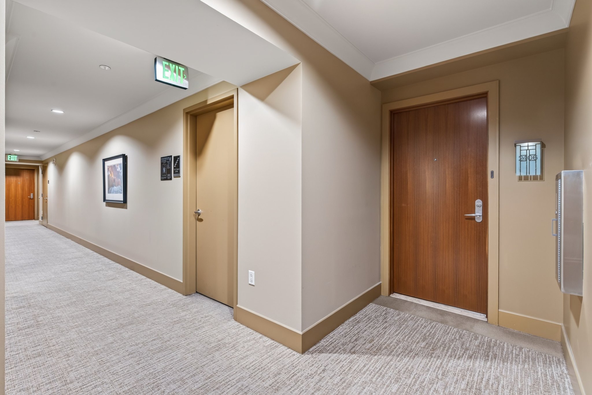Building corridor featuring recessed lighting and wall sconces