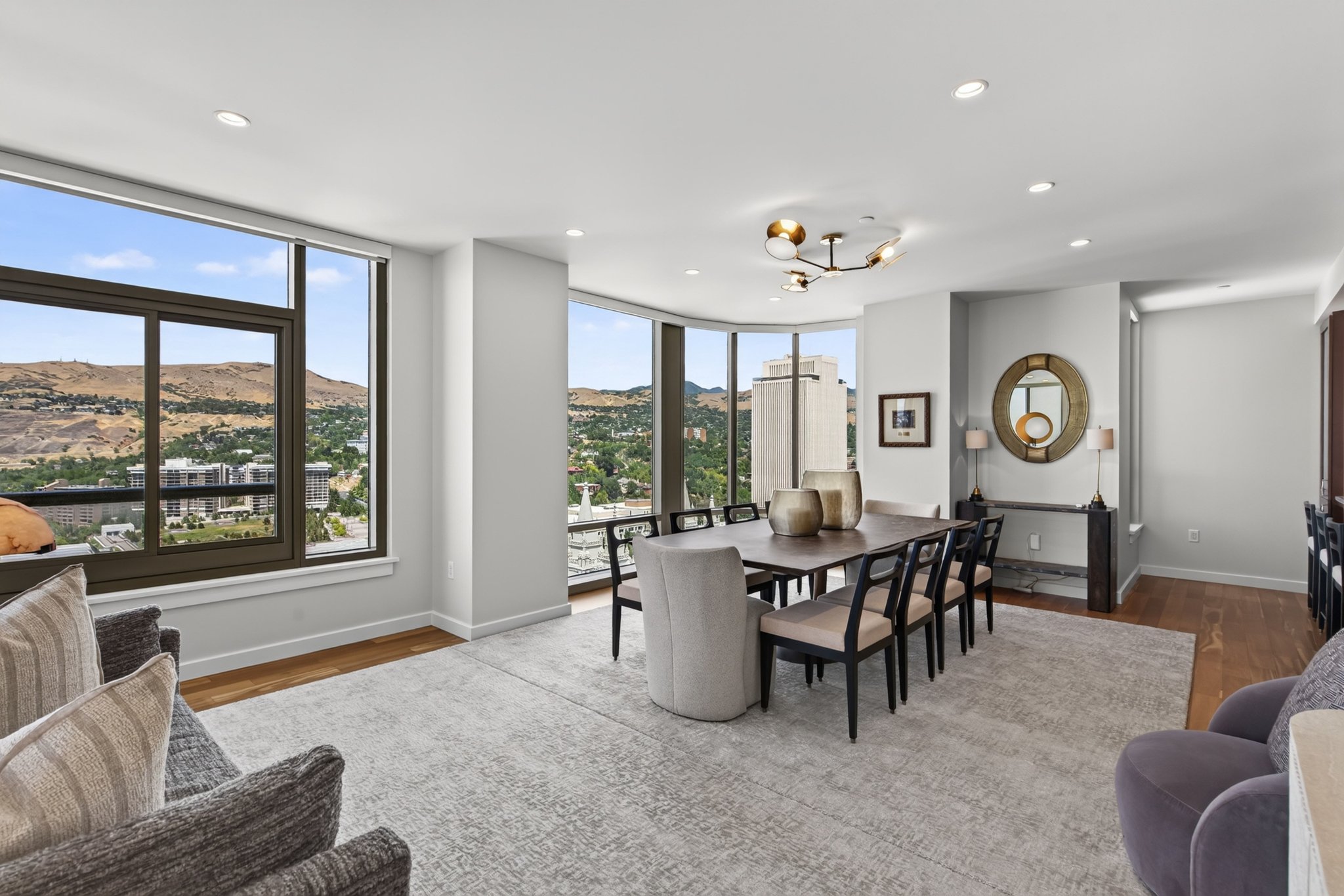 Spacious dining area featuring expansive windows, recessed lighting, wood-finish flooring, and a modern chandelier