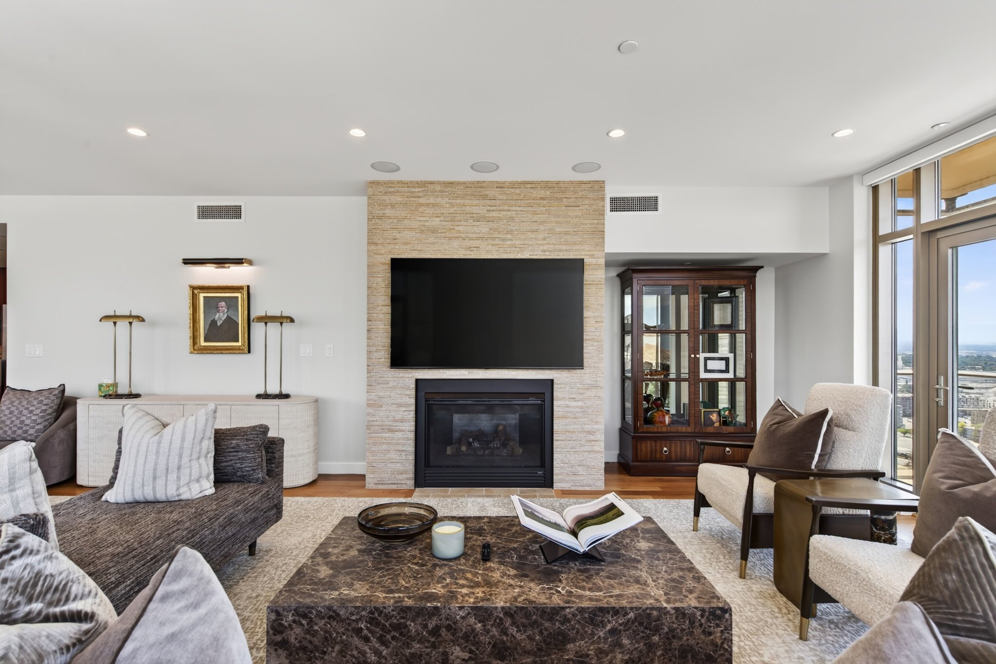 Living area with a stone-clad fireplace and integrated television