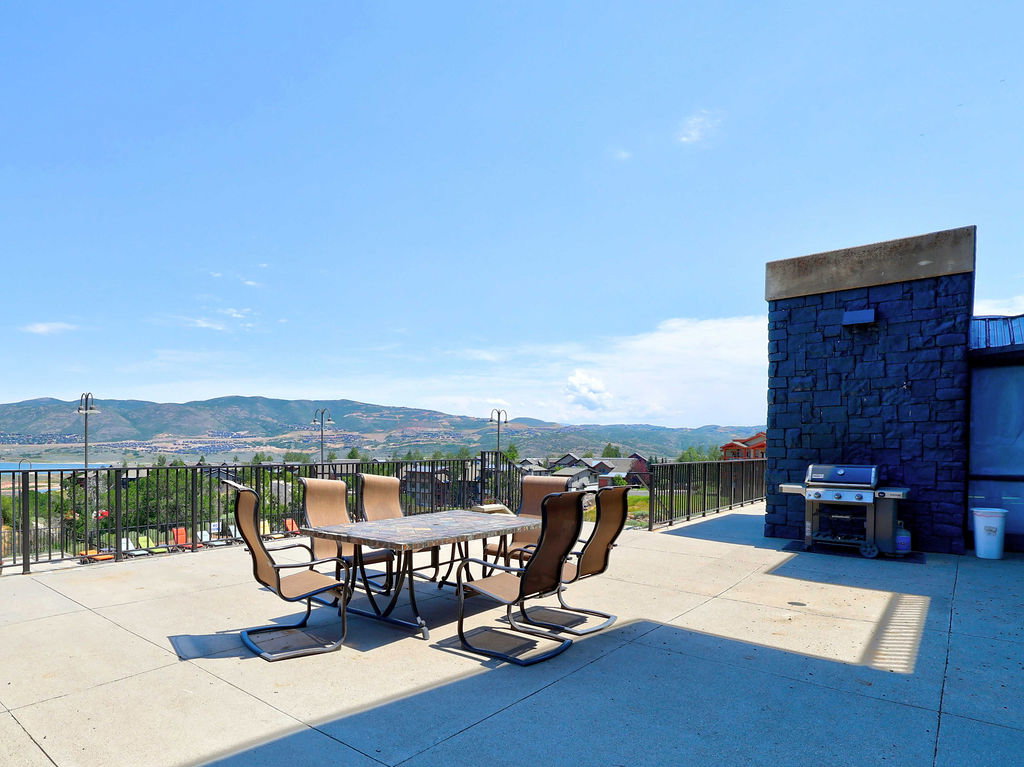 Expansive dining patio and BBQ, offering broad mountain and water scenery