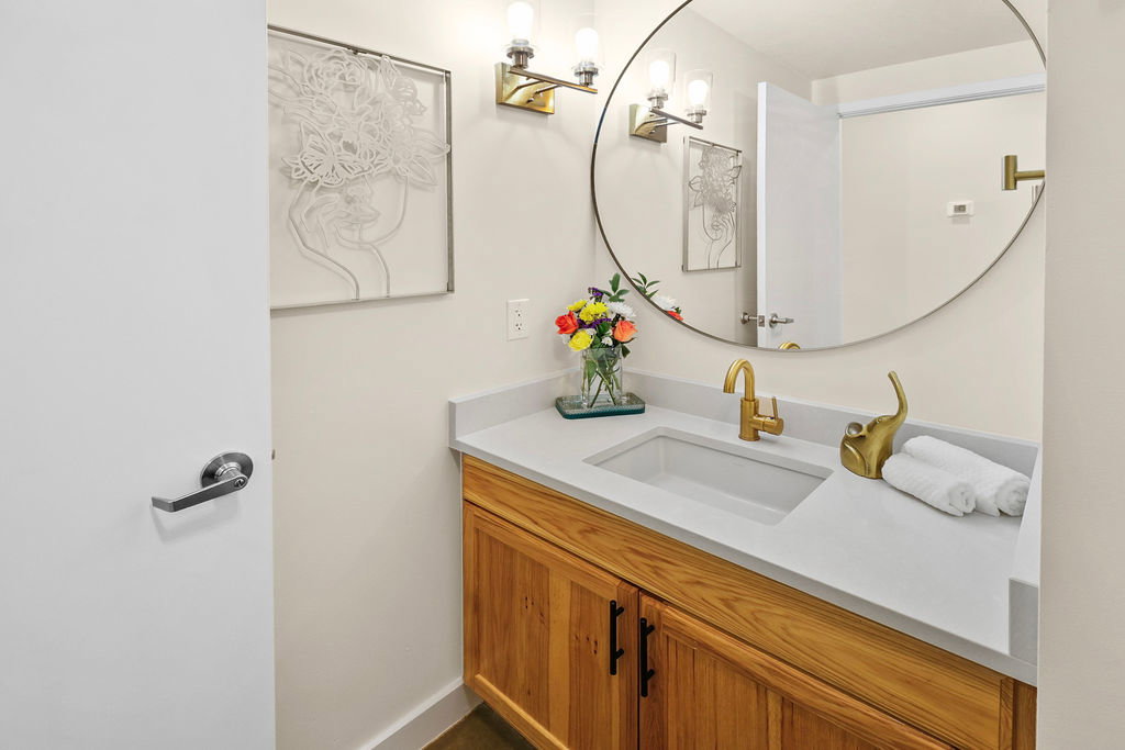 Solid surface countertop, solid wood vanity and slate floor