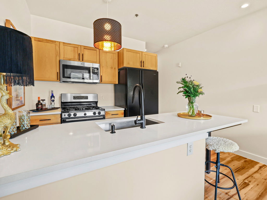Contemporary kitchen featuring solid wood cabinetry and solid surface countertops