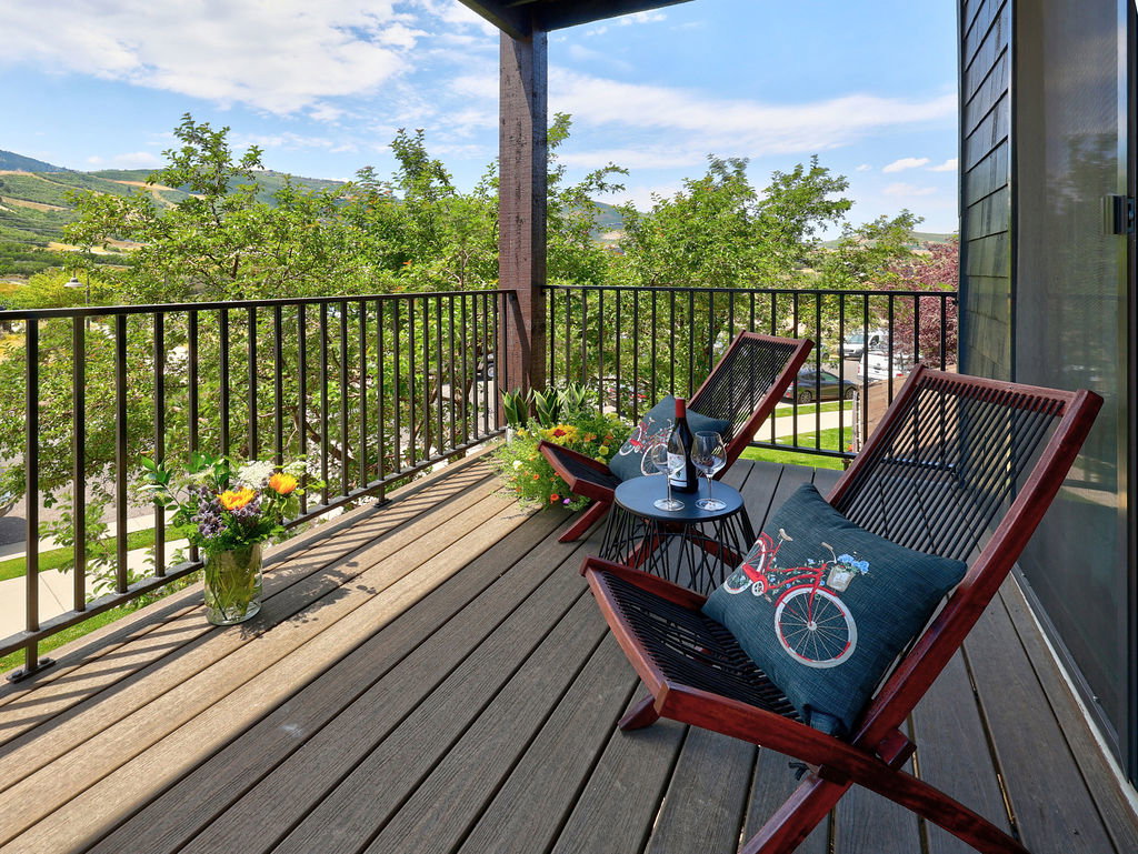 Spacious view balcony that can accommodate a dining set. Composite decking and black metal railings