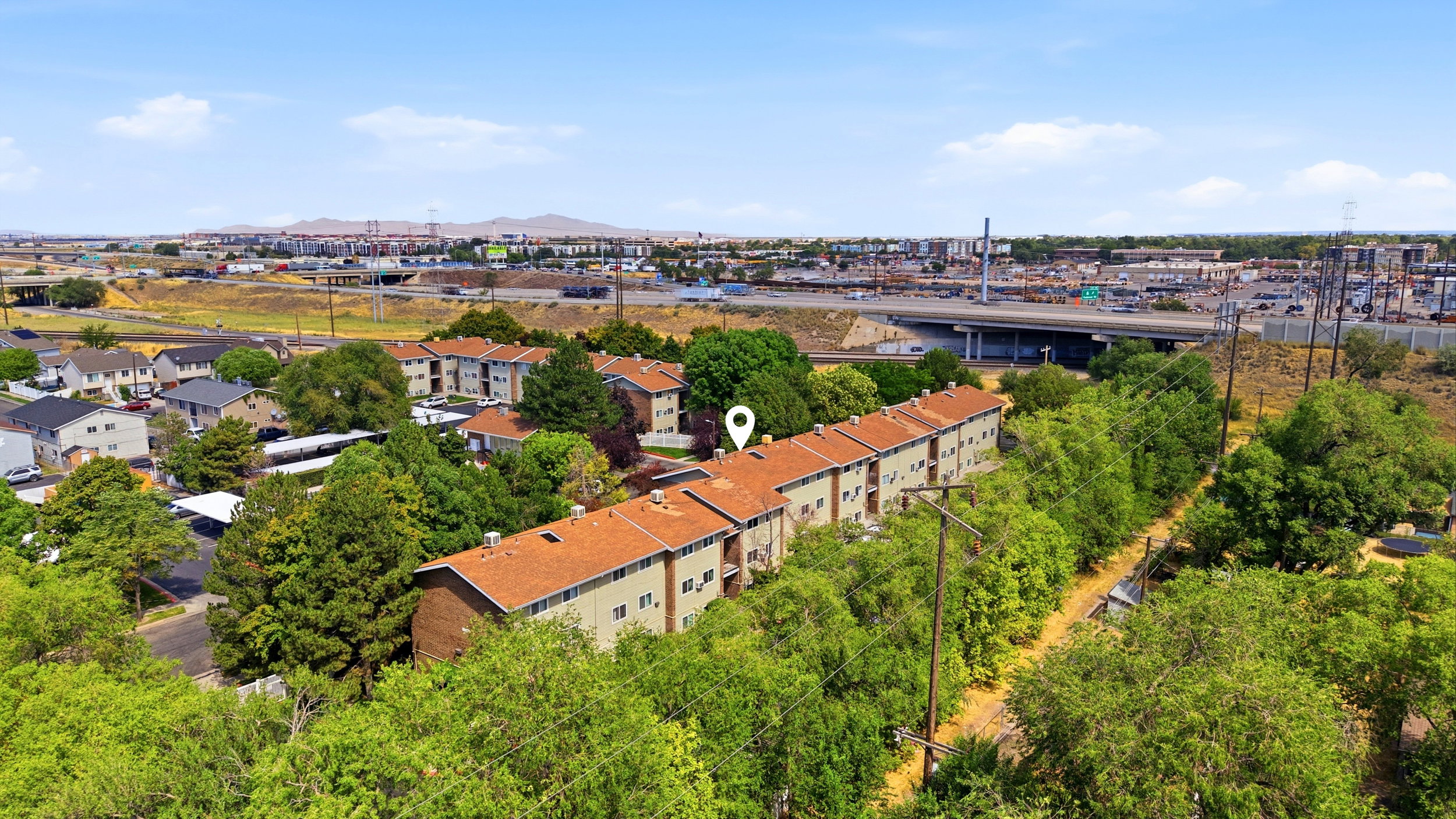 Multi-unit residential buildings featuring terracotta-style roofing and light-toned siding
