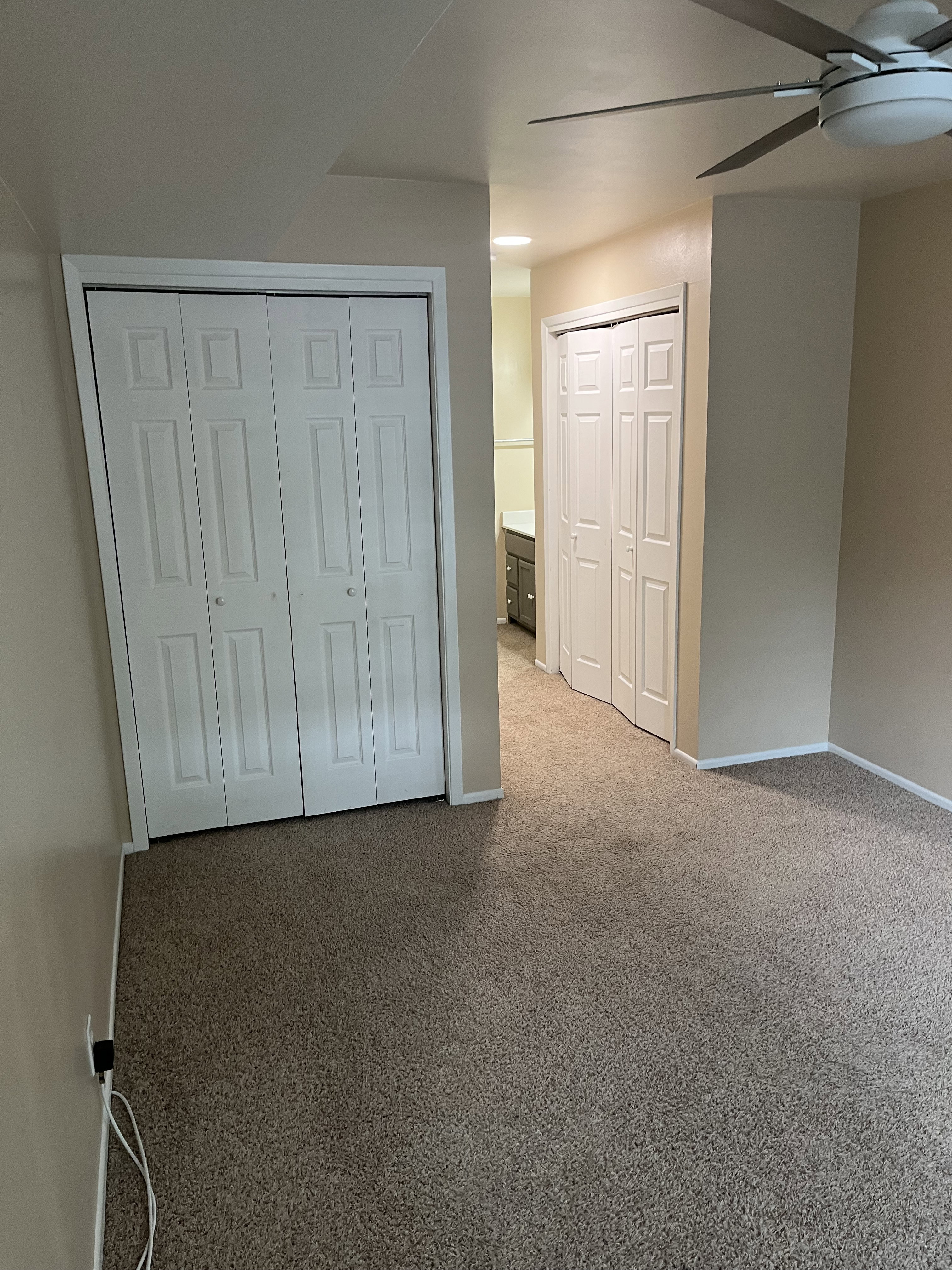Wall-to-wall carpeting and neutral wall tones define this interior space