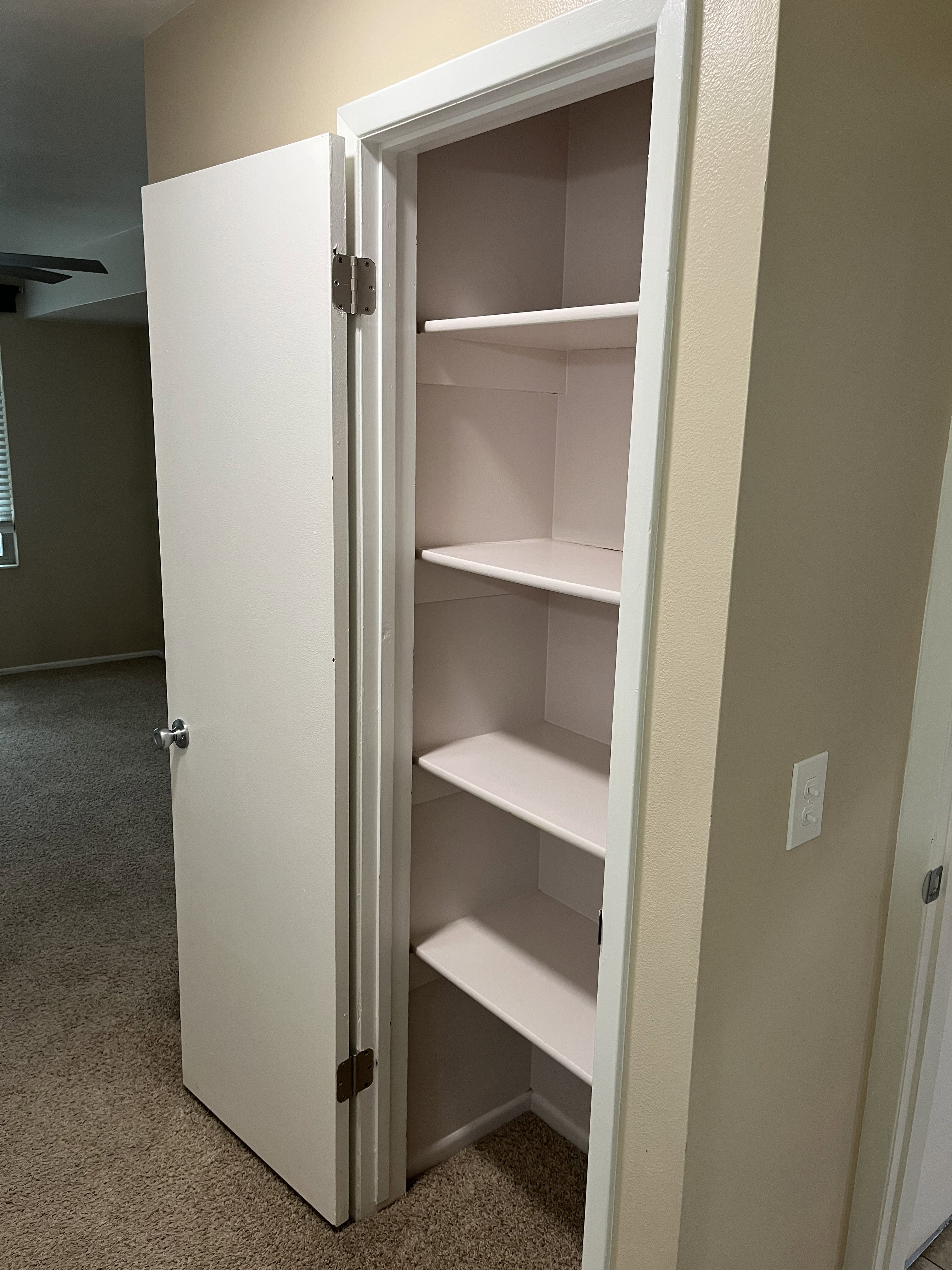Built-in storage closet featuring multiple shelves