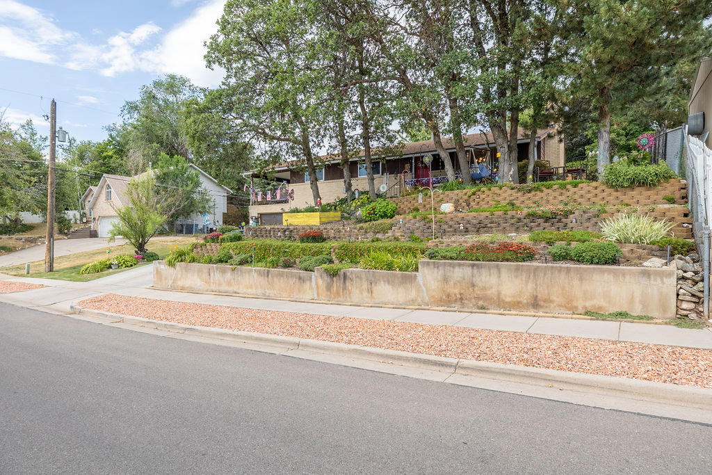 Terraced front yard with concrete retaining walls and mature landscaping