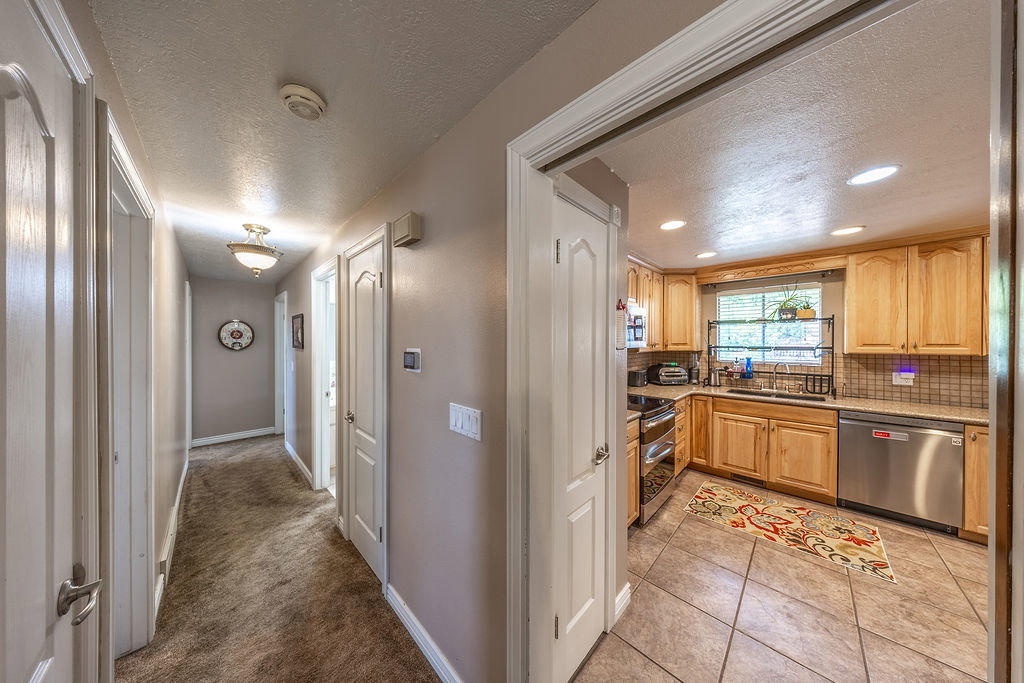 Kitchen featuring recessed lighting, a window, wood cabinetry, stainless steel appliances, and a tiled backsplash