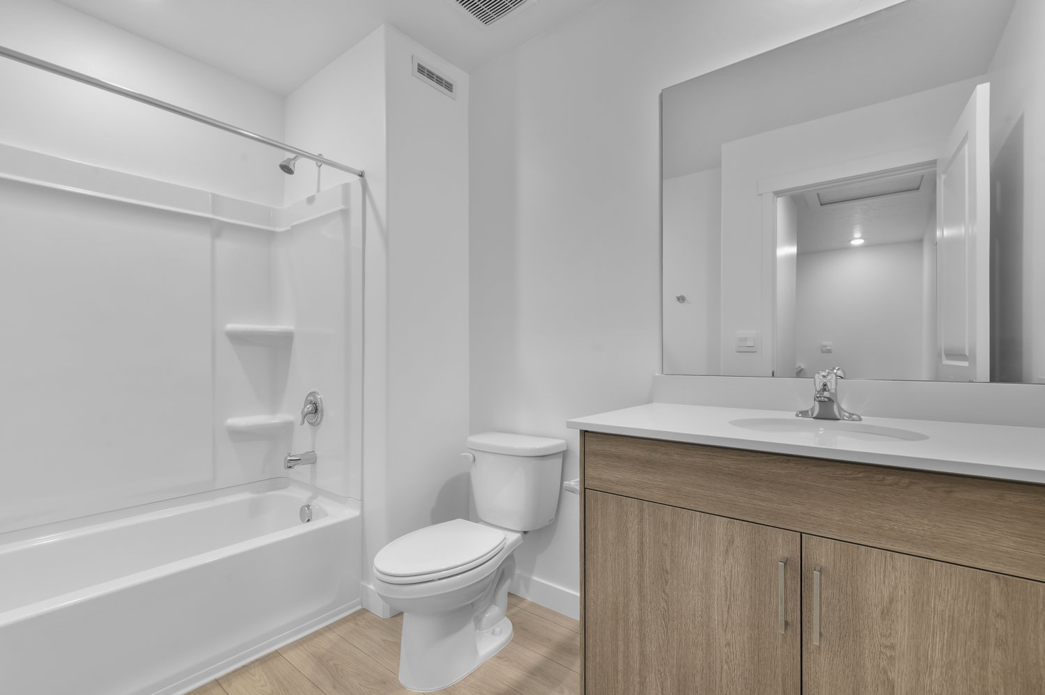 Bathroom featuring a modern vanity with wood-finish cabinetry and a white countertop