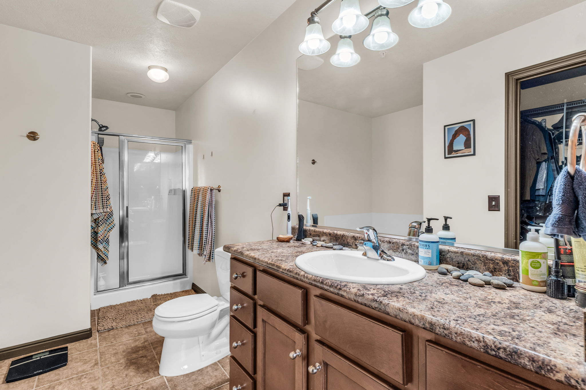 Bathroom featuring a built-in vanity with an undermount sink, and a chrome faucet