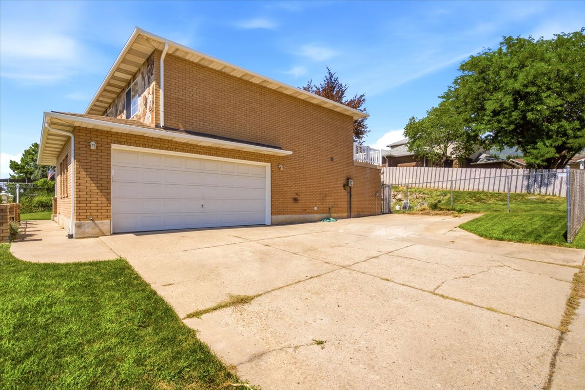 Two-car garage with a white overhead door, complemented by a brick and stone exterior