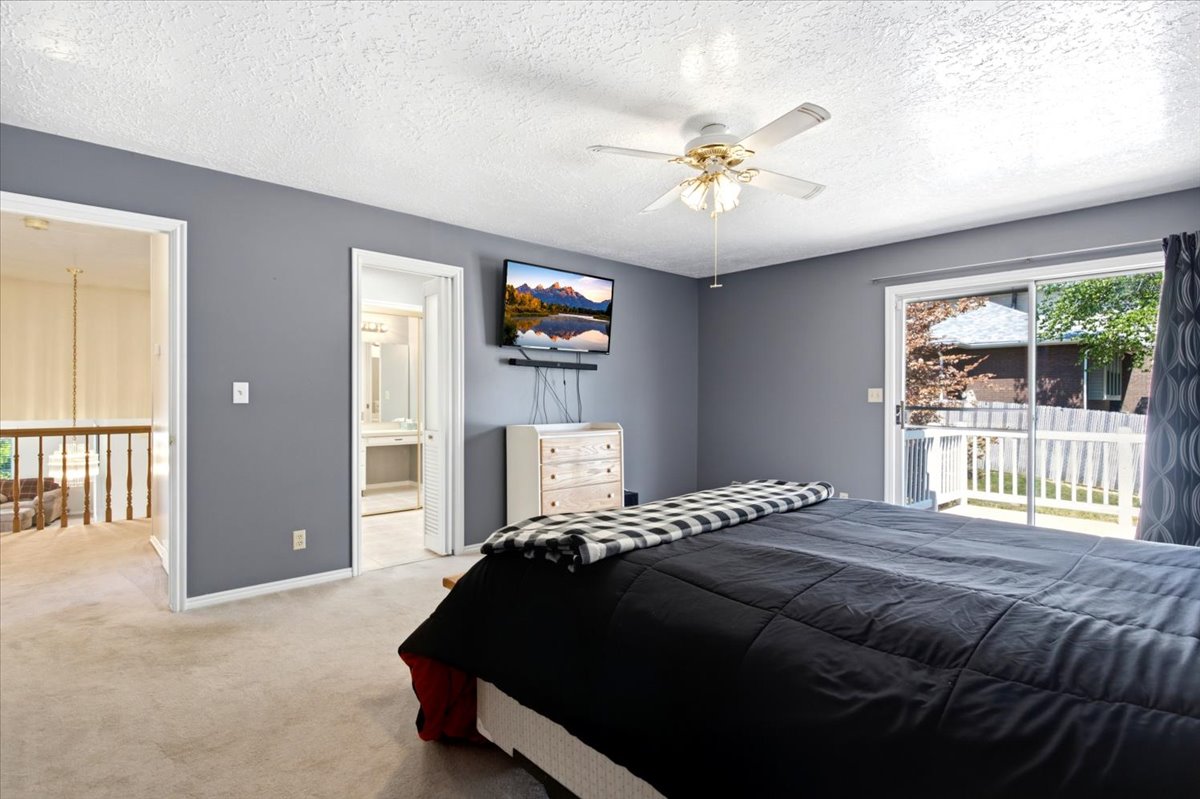 Spacious room featuring neutral carpeting and a ceiling fan