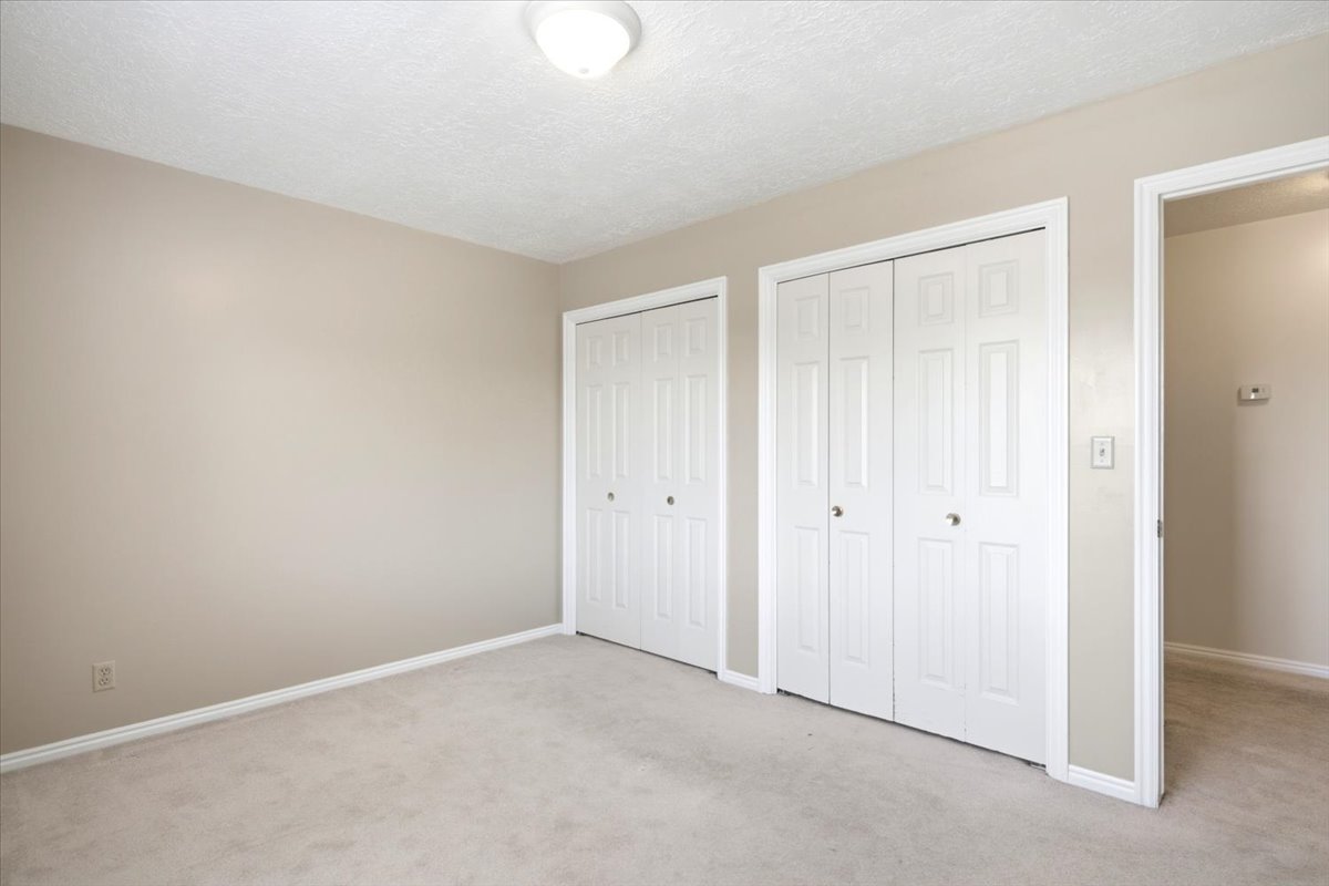 Neutral-toned carpeting paired with light beige walls