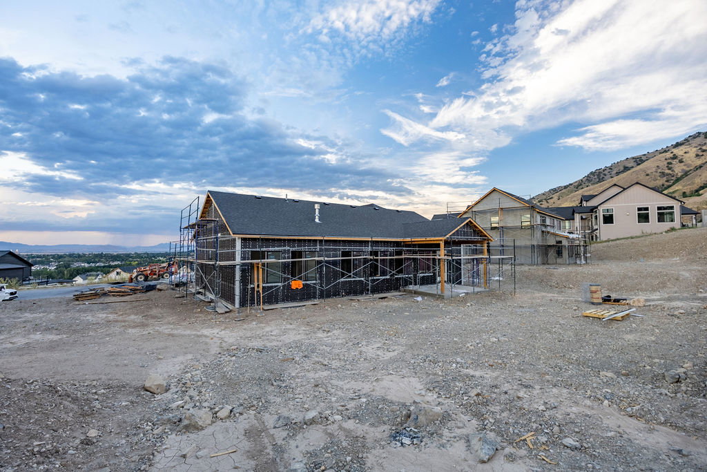New construction property featuring a dark shingle roof and partially framed exterior
