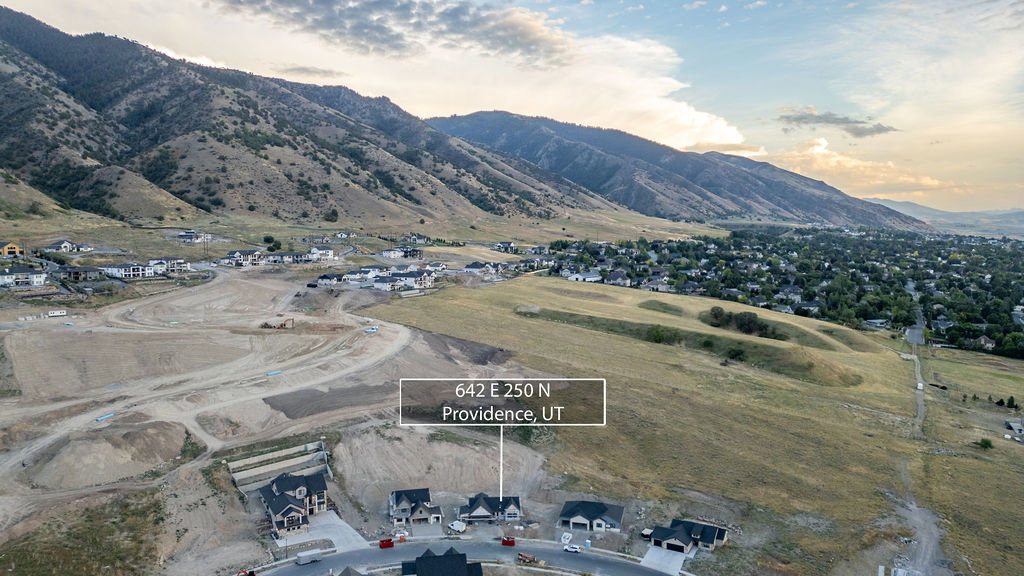 Expansive developable land with mountain backdrop, established residential areas, and infrastructure for future builds