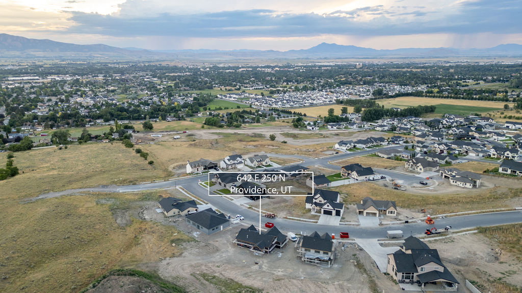 New construction homes situated on paved roads with mountain scenery